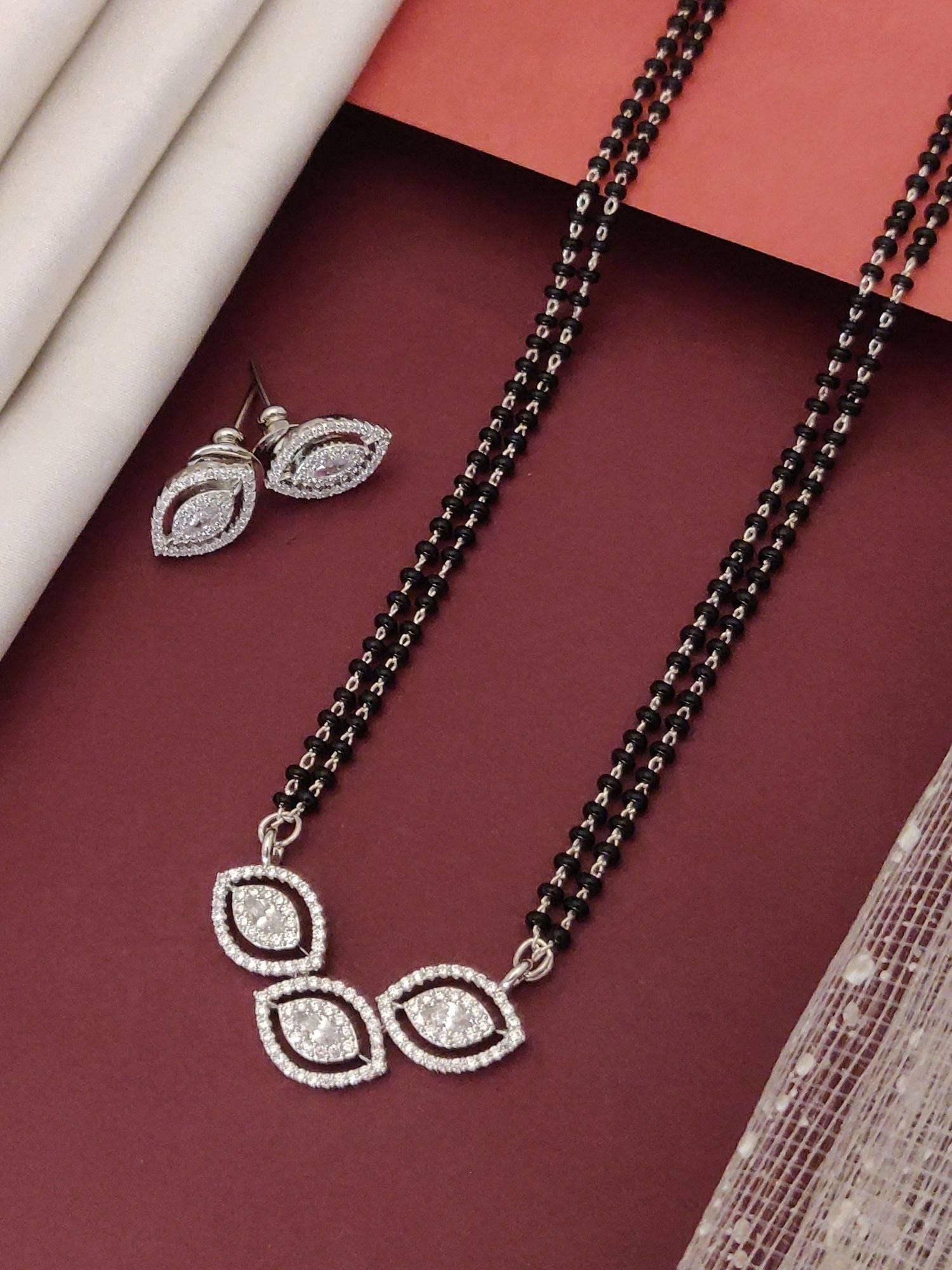 Elegant affordable mangalsutra set with black beads and sparkling pendant, includes matching earrings