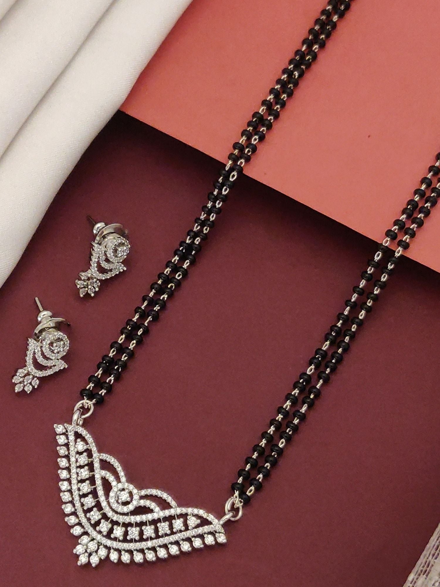 Elegant American diamond mangalsutra with earrings featuring intricate design and black beads