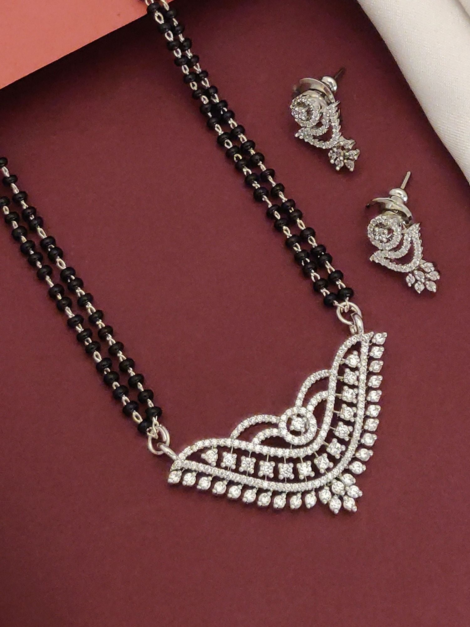 Elegant American diamond mangalsutra with earrings, featuring intricate design and shining accents
