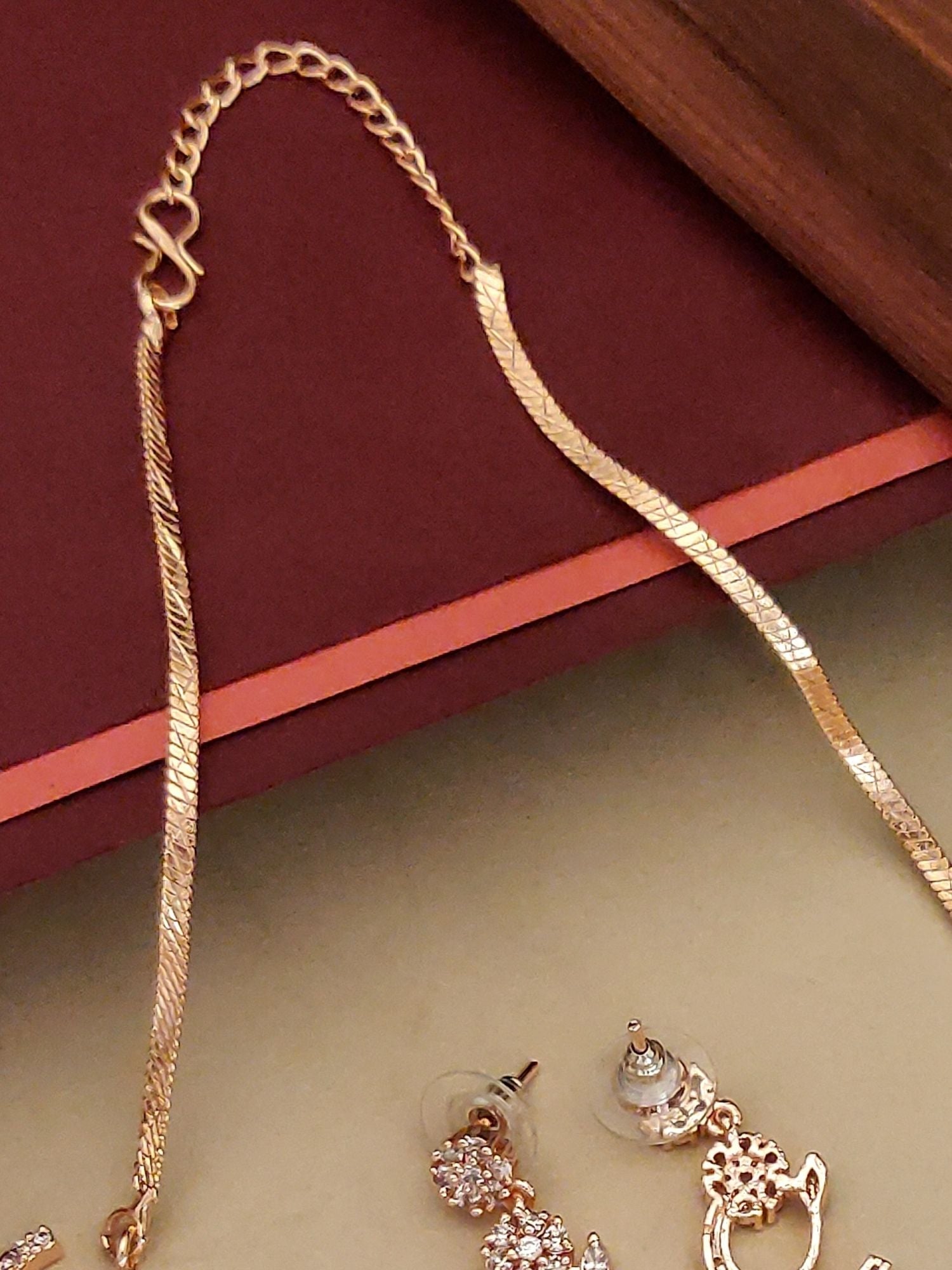 Abdesignsjewellery gold pendant chain with floral American diamond necklace set and matching stud earrings on display