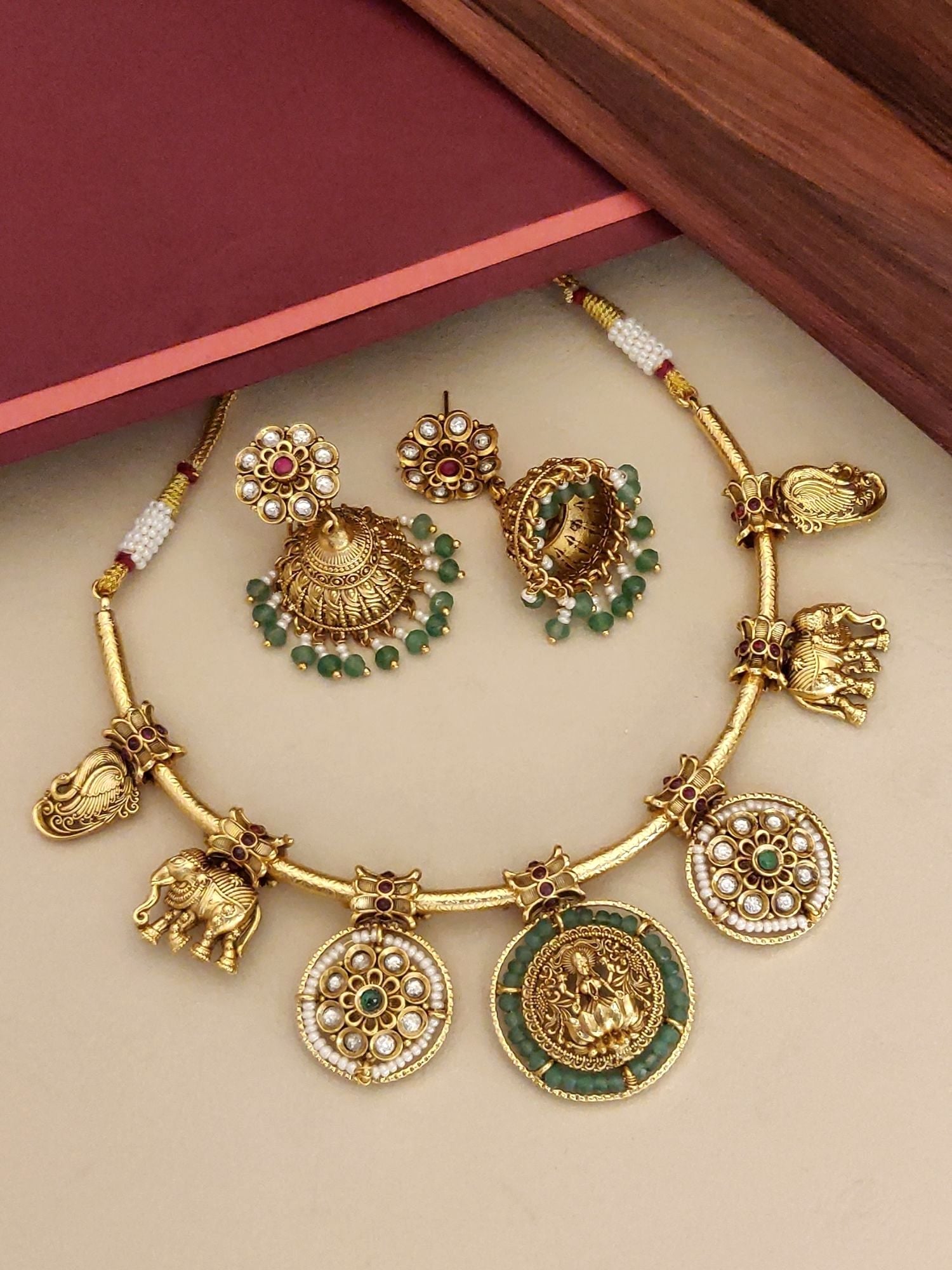 Antique Emerald Green Temple Hasli Neckl with gold finish and intricate elephant and floral charms