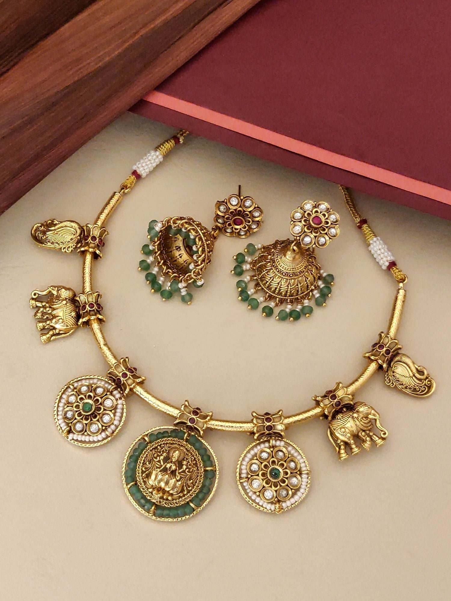 Antique Emerald Green Temple Hasli Neckl gold necklace with temple motifs and matching green bead jhumka earrings