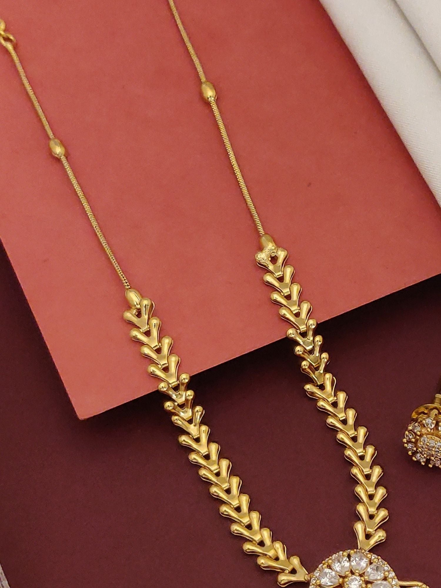 Antique Gold Plated American Diamond Pearl Necklace Set by Abdesignsjewellery featuring gold leaf link chain and crystal pendant