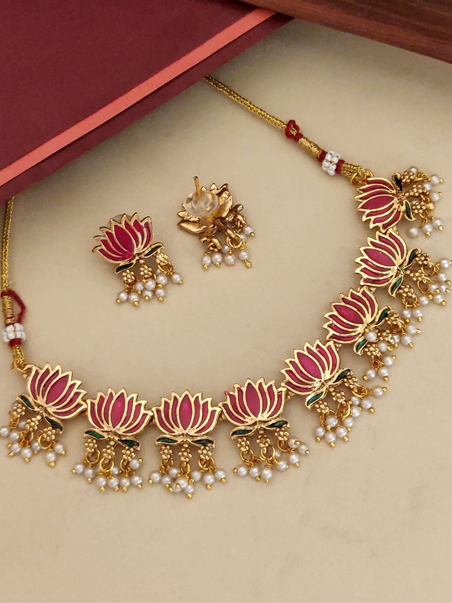 Antique lotus necklace set featuring gold and pink lotus designs with pearl accents