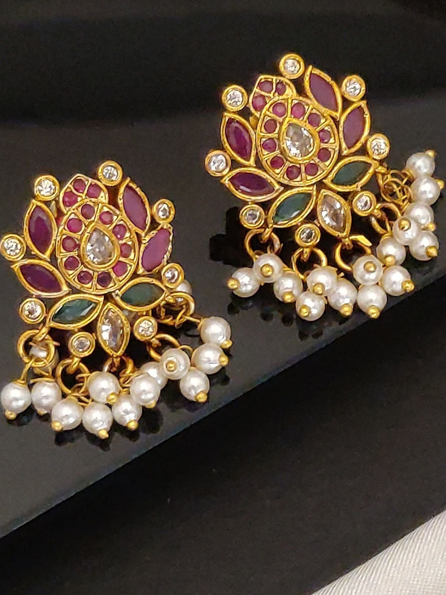Artificial Floral gold jhumka earrings for women with intricate pink and green design and pearl detailing