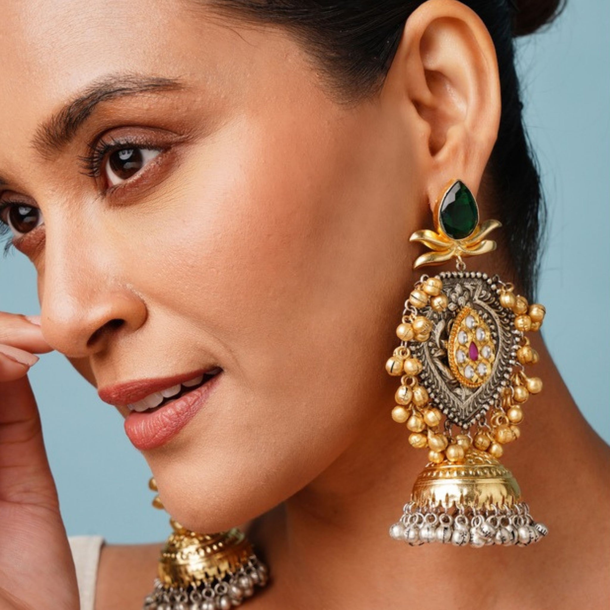 Beautiful DualTone Pachi Kundan Jhumka Earring worn by woman showcasing intricate gold and green design