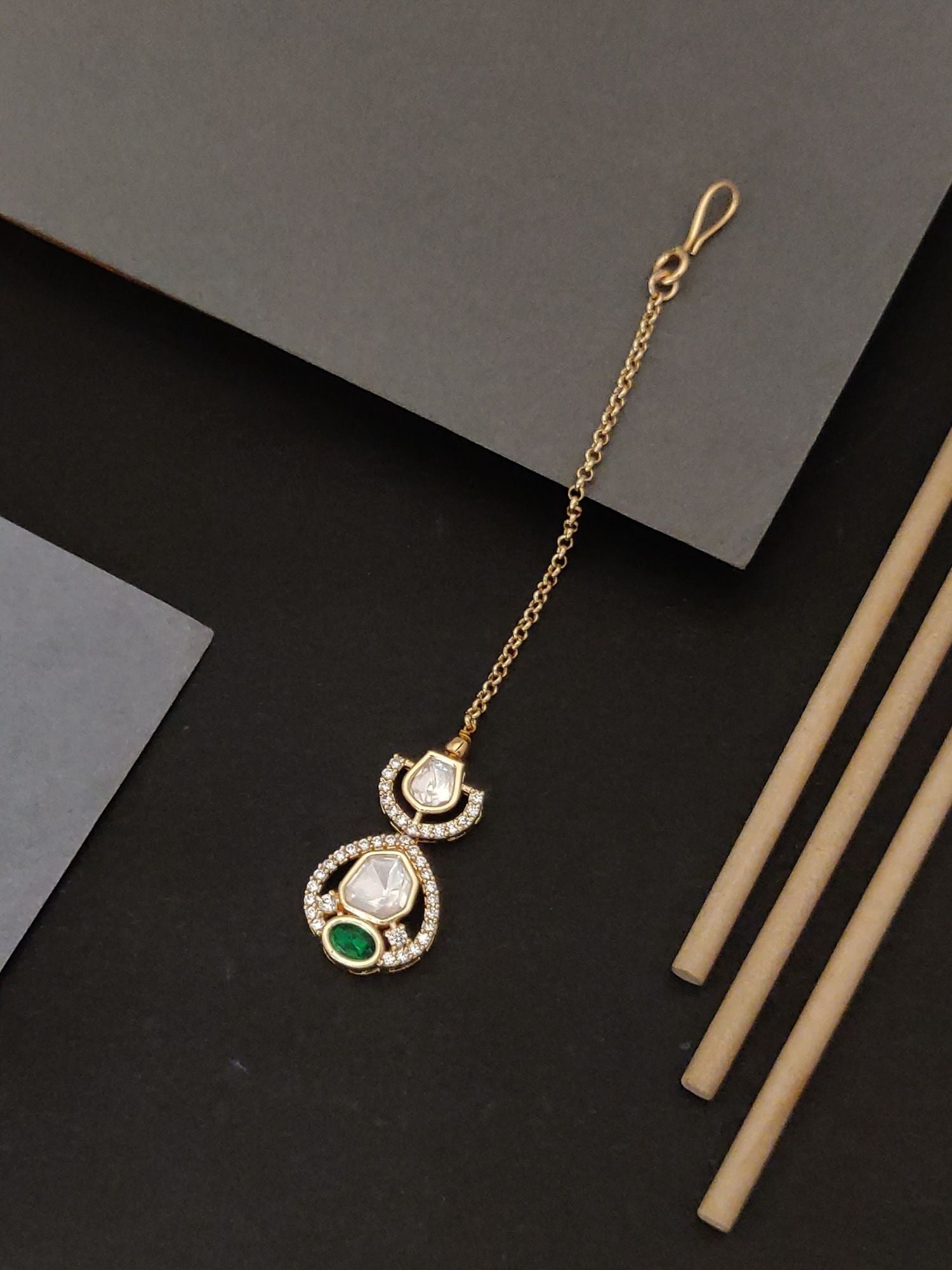 Beautiful gold plated polki maangtikka with green and white stones on a gold chain by Abdesignsjewellery