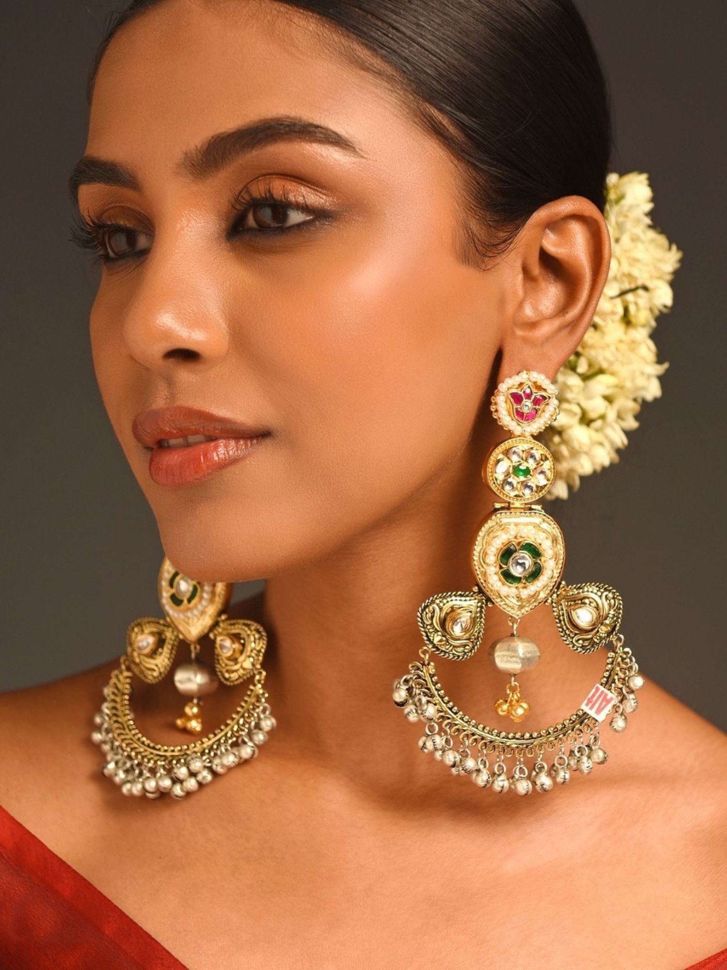 Cultural Dual Tone Plated Long Earring worn by woman with intricate design and pearl accents