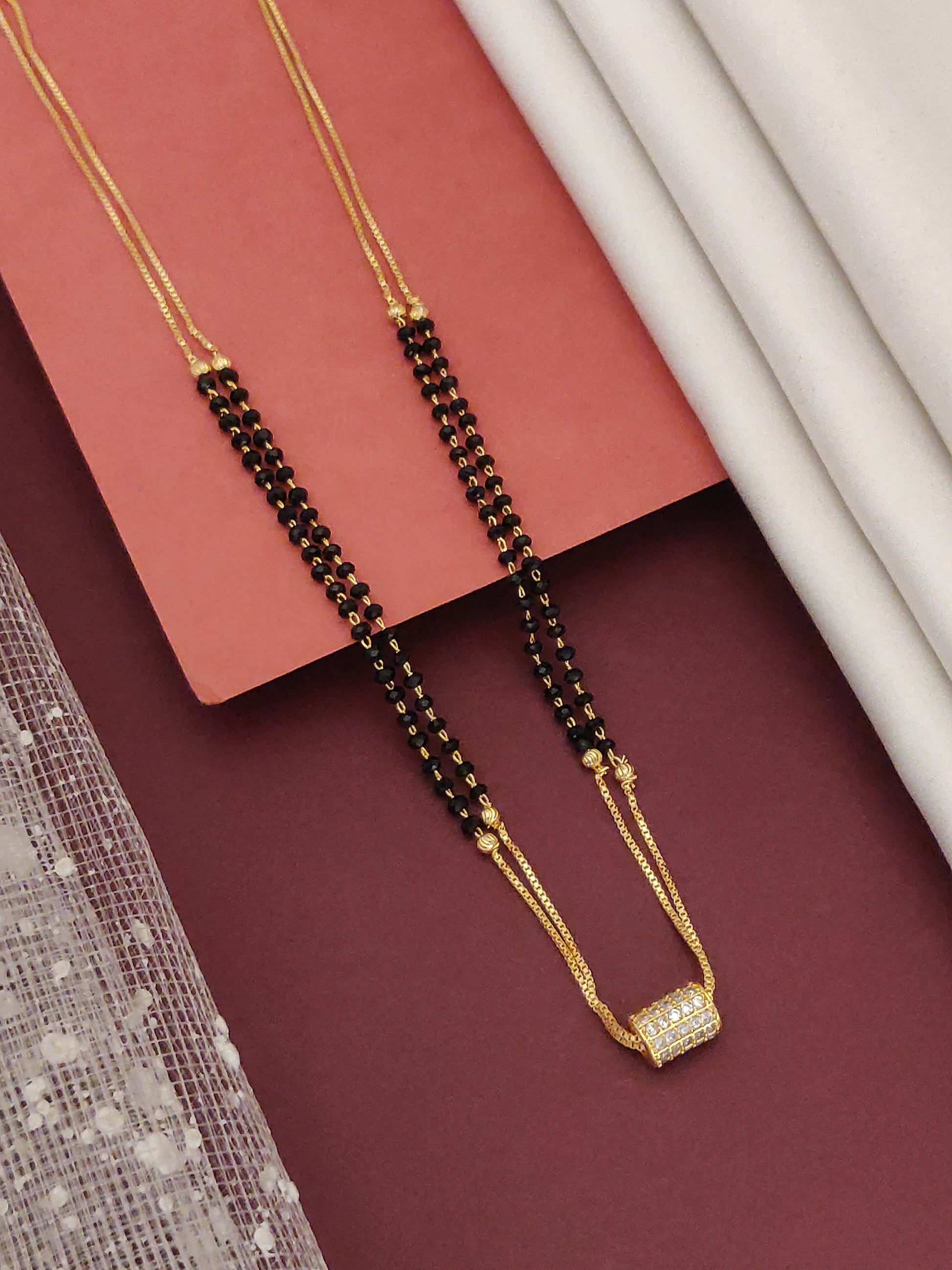 DailyWear Gold Plated American Diamond Mangalsutra featuring elegant black beads and a stylish pendant.