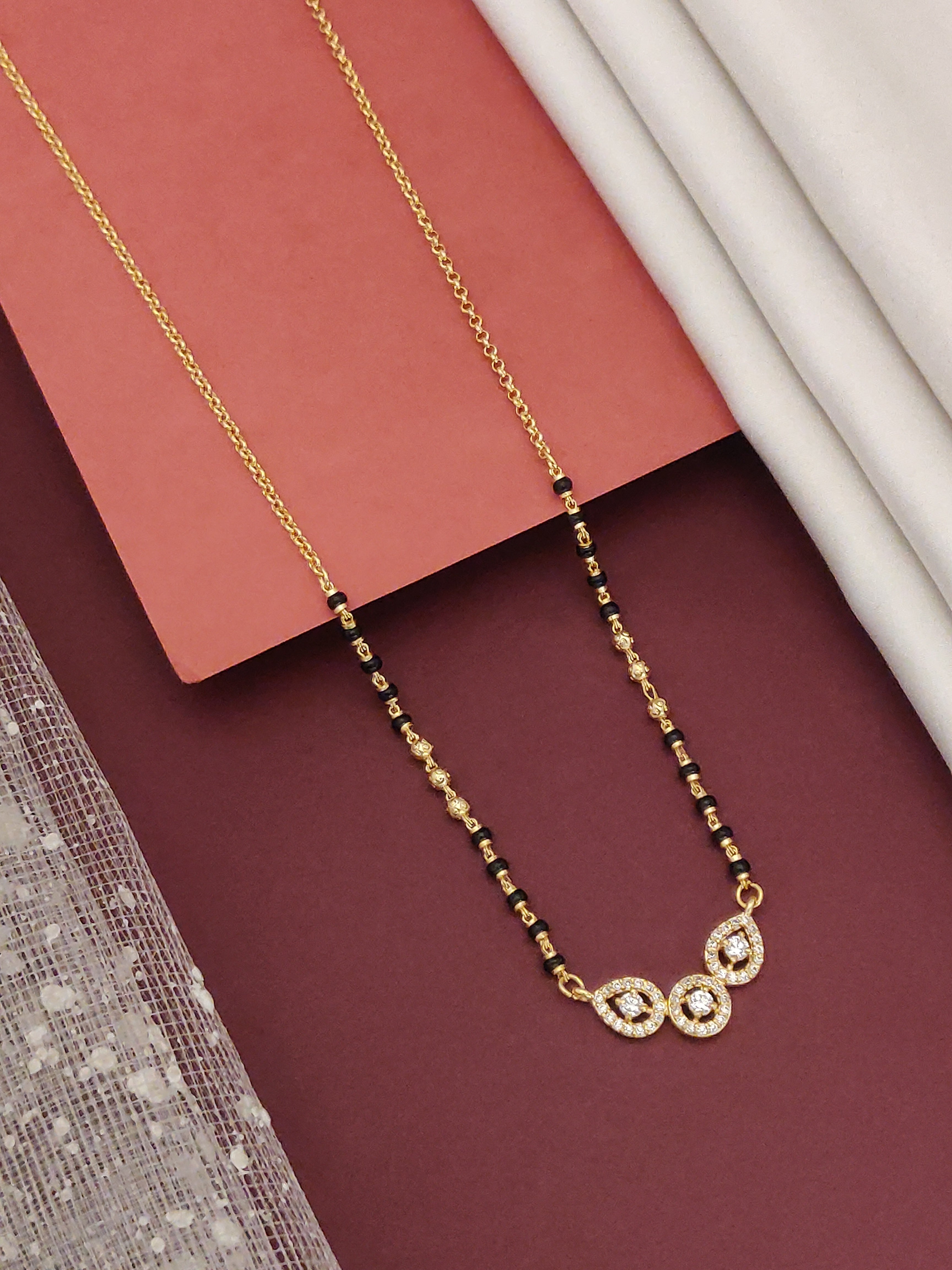 Elegant DailyWear Gold Plated American Diamond Mangalsutra showcasing a unique design with gold and black beads