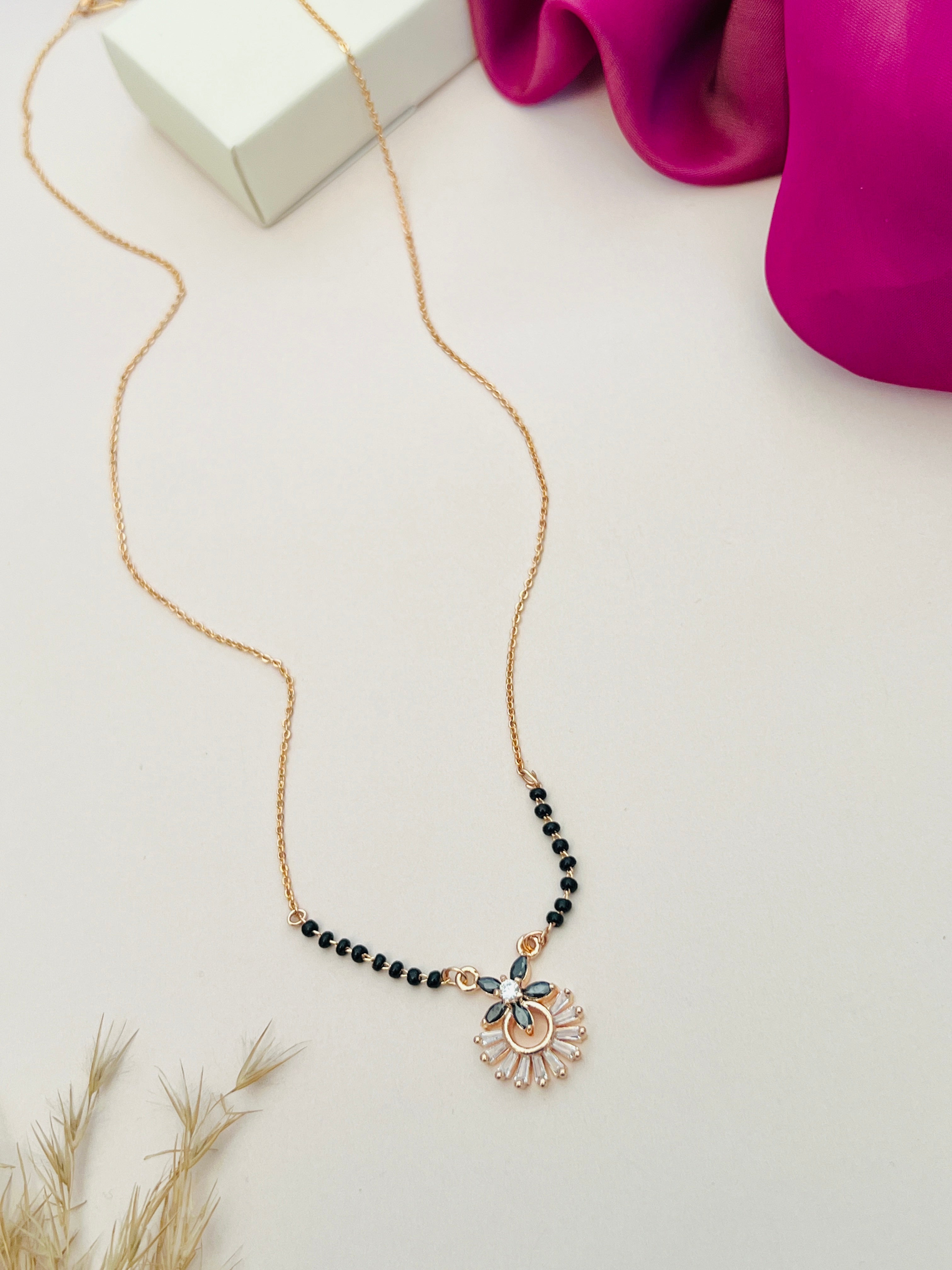 Abdesignsjewellery Dazzling American Diamond Mangalsutra with black beads and floral pendant on gold chain