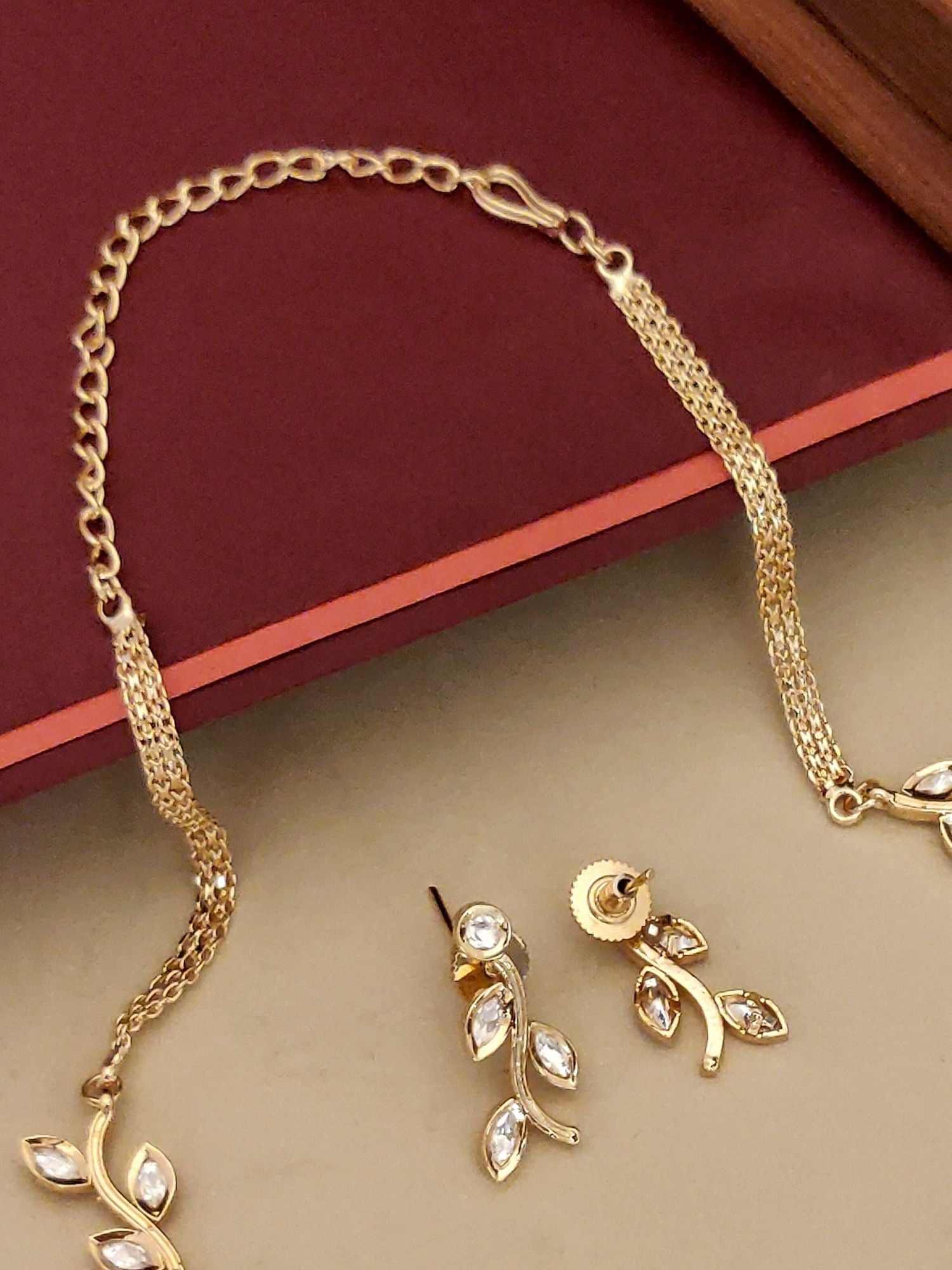Abdesignsjewellery gold leaf necklace and matching earrings showcasing delicate artificial jewelry set for women
