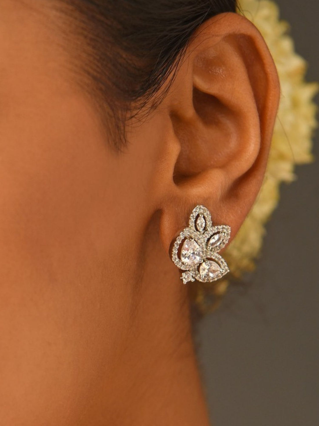 Abdesignsjewellery elegant designer floral studs on model showing sparkling crystal petal cluster earrings