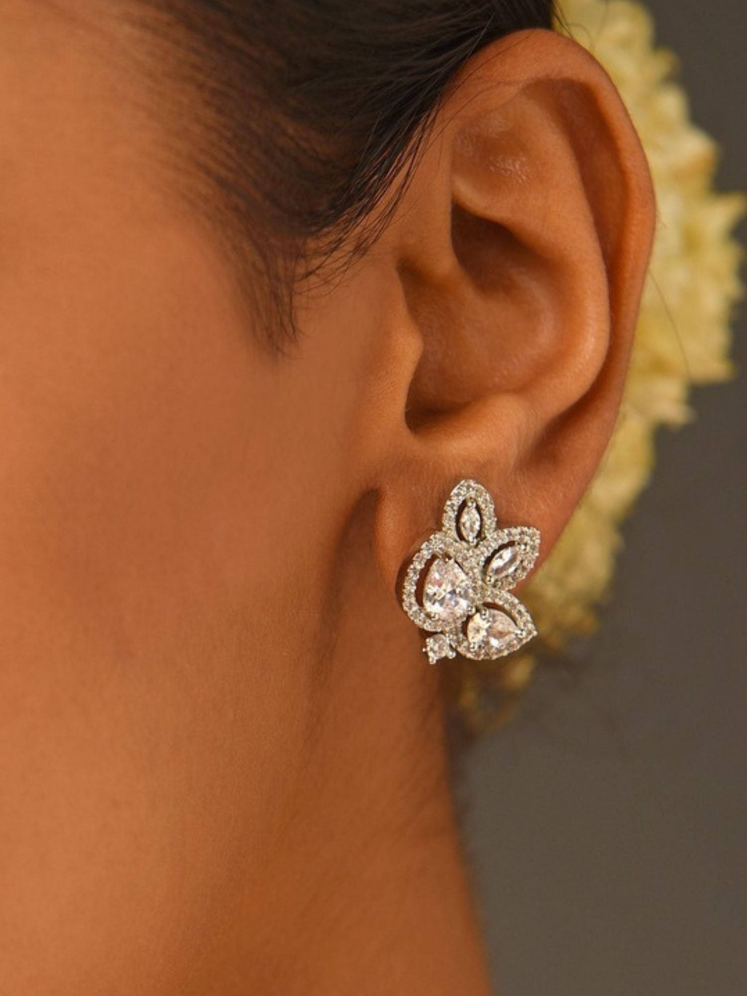 Close up of ear wearing Abdesignsjewellery elegant designer floral studs silver crystal cluster earrings