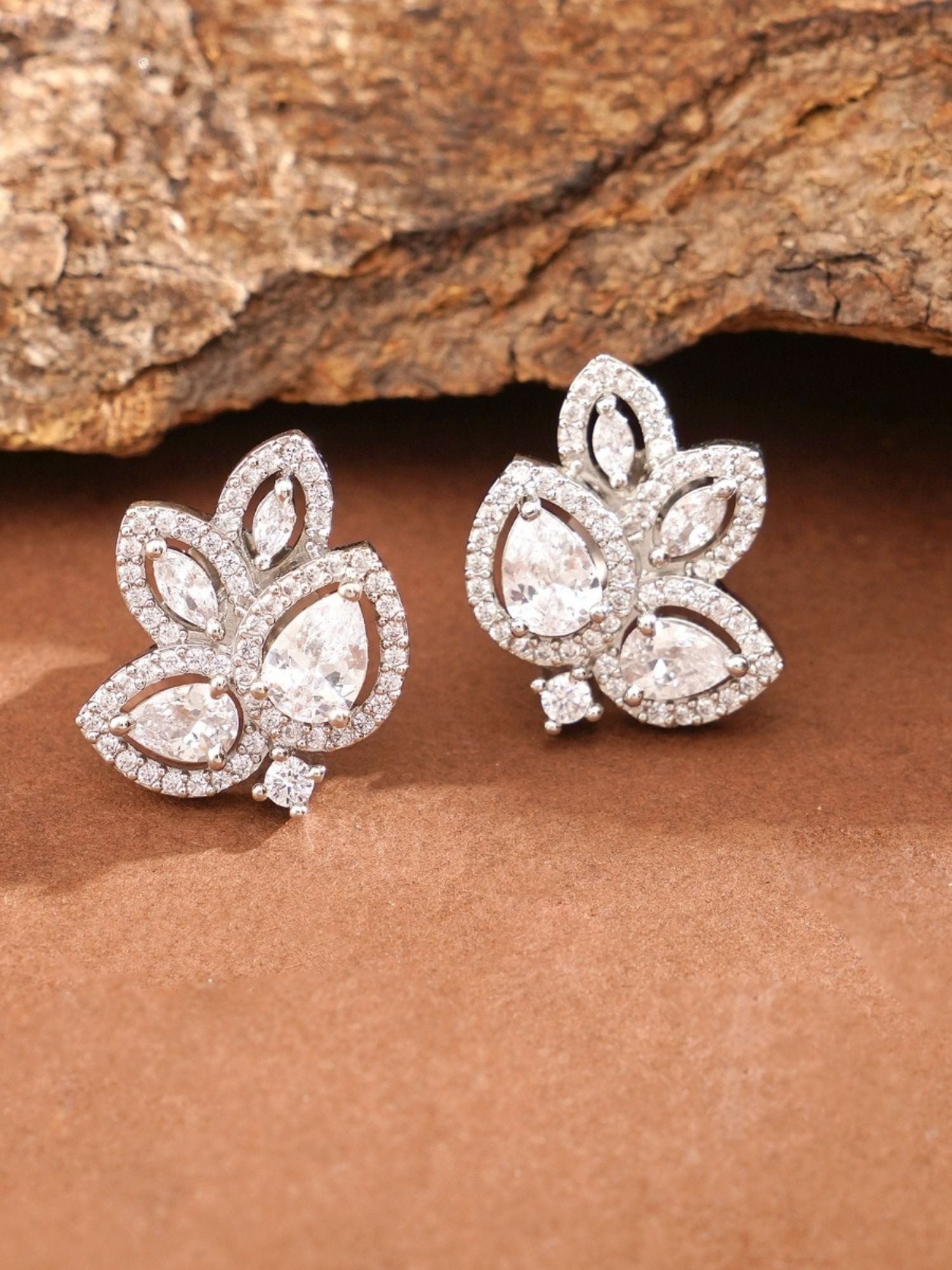 Abdesignsjewellery elegant designer floral studs silver cubic zirconia leaf petal stud earrings on wood