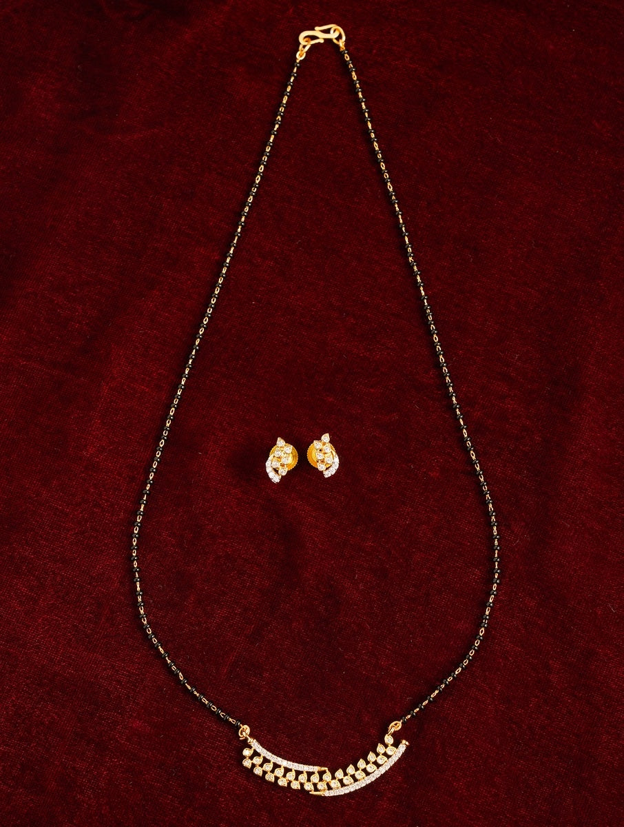 Elegant Gold Plated American Diamond Mangalsutra Set with matching earrings on a dark red background