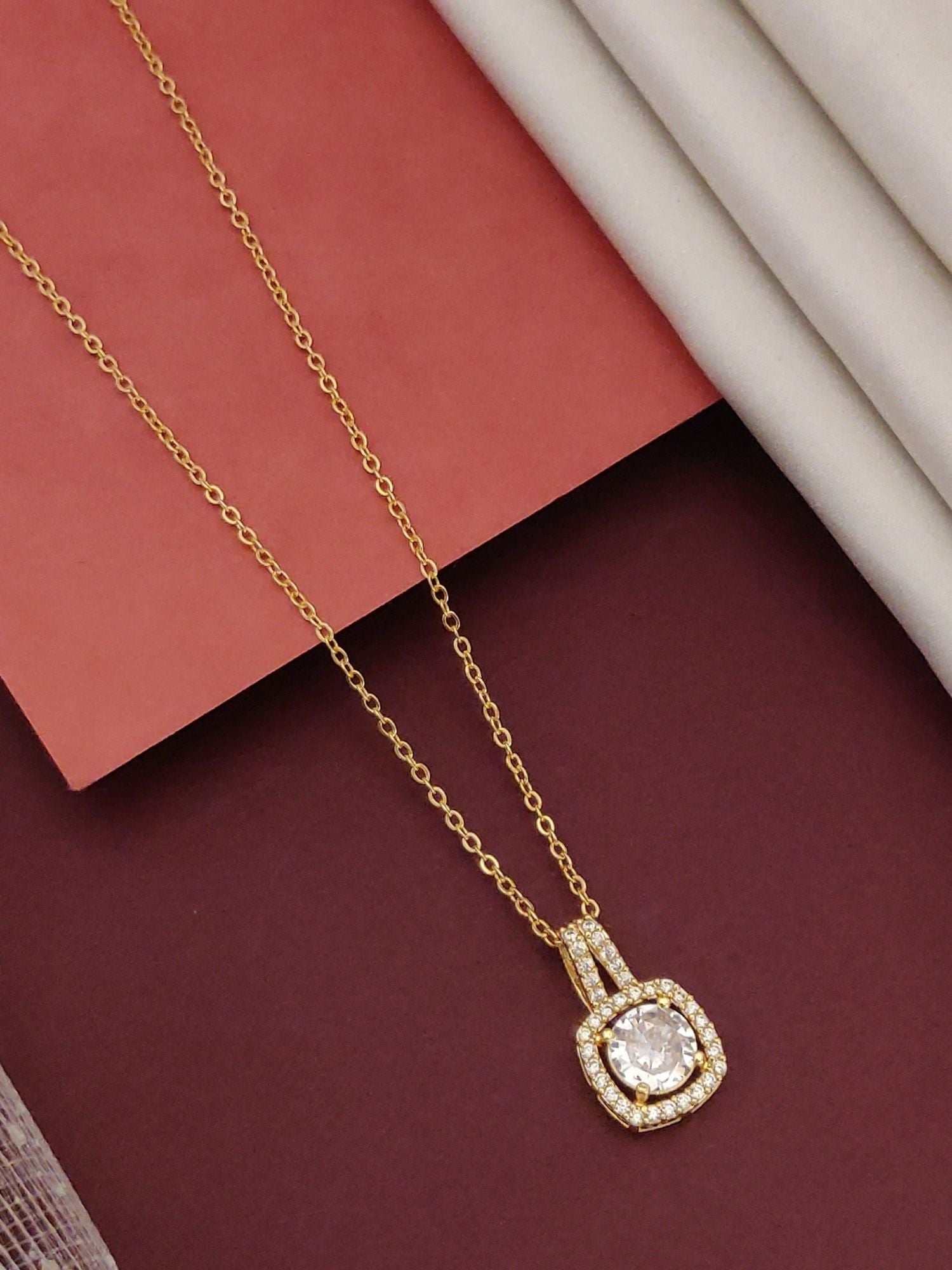 Elegant gold plated pendant necklace featuring a sparkling center stone surrounded by shimmering accents
