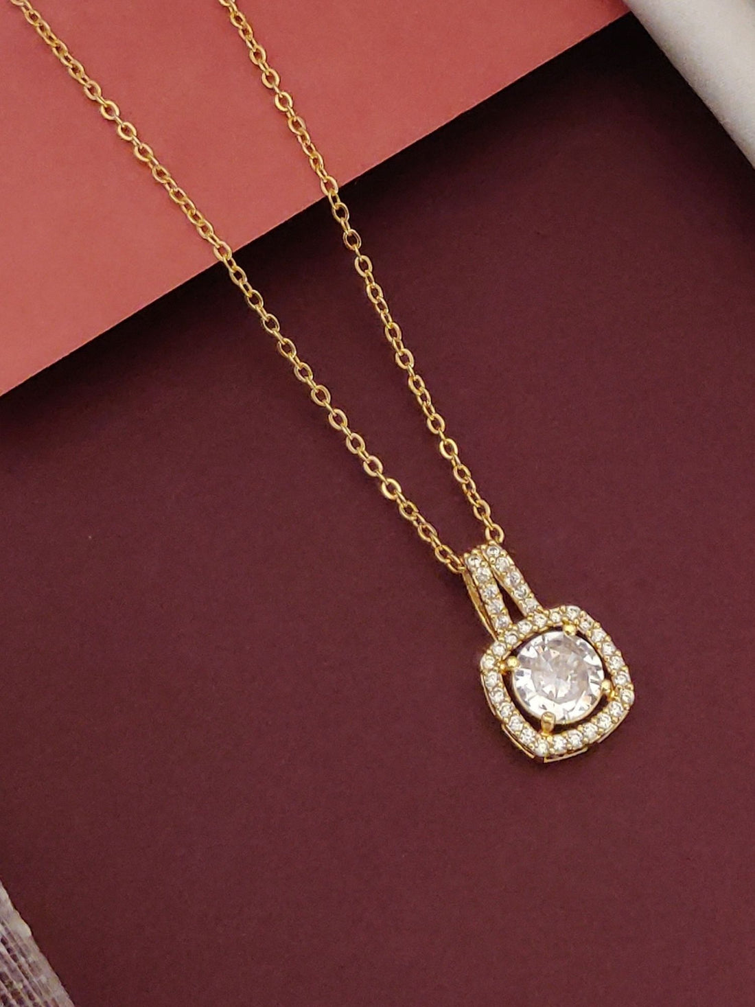 Elegant gold plated pendant necklace featuring a sparkling center stone surrounded by shimmering accents