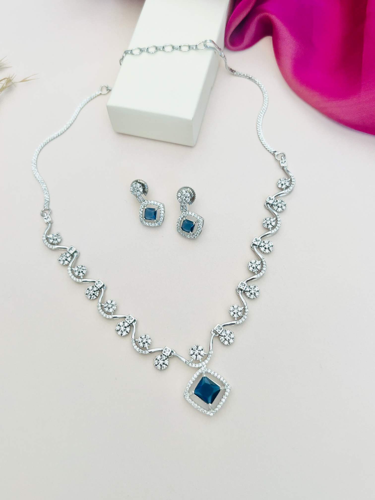 Elegant Necklace with Sparkling Stones featuring blue center stones and matching earrings by Abdesignsjewellery