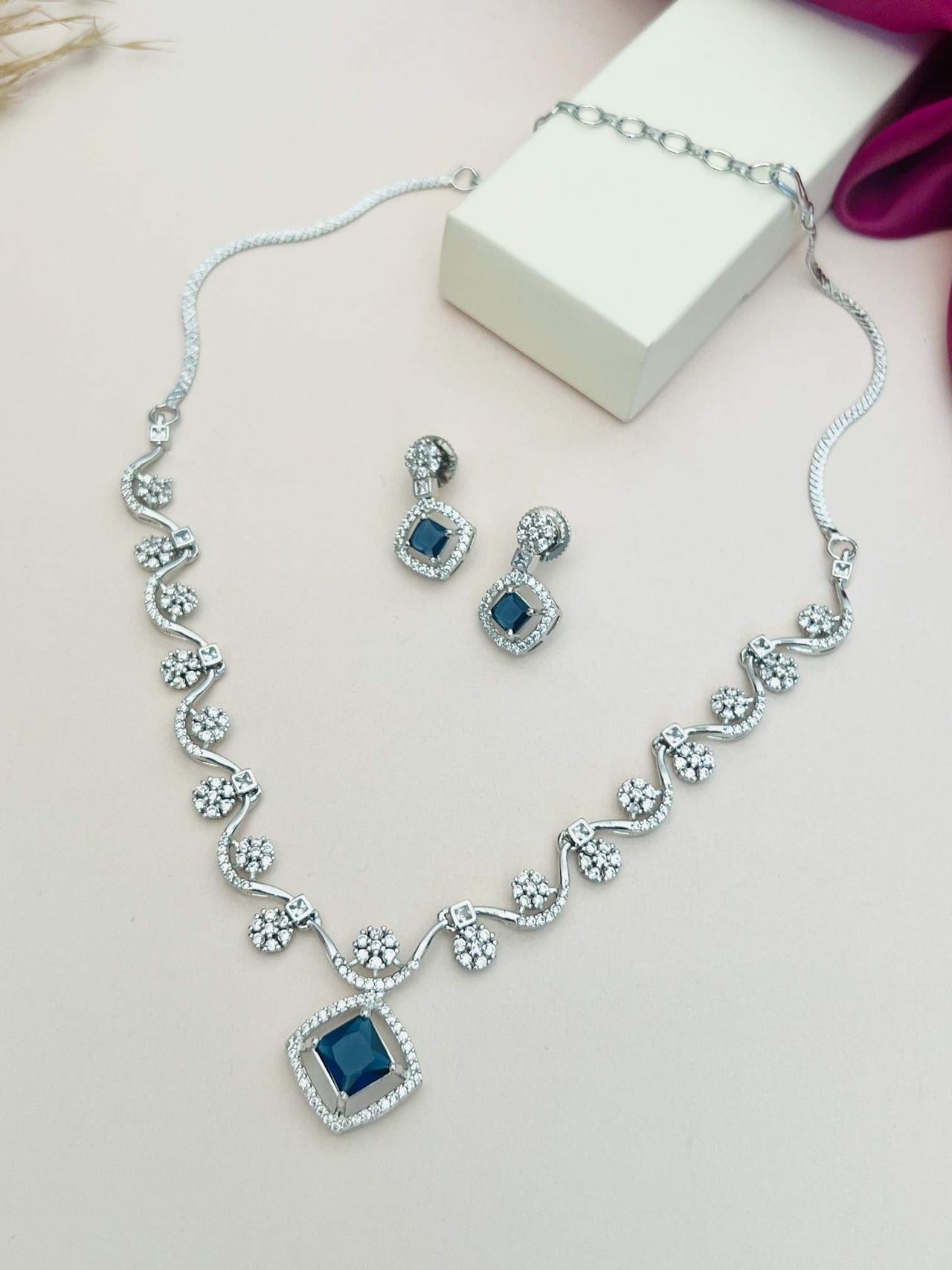 Elegant Necklace with Sparkling Stones and matching earrings featuring blue center stones by Abdesignsjewellery