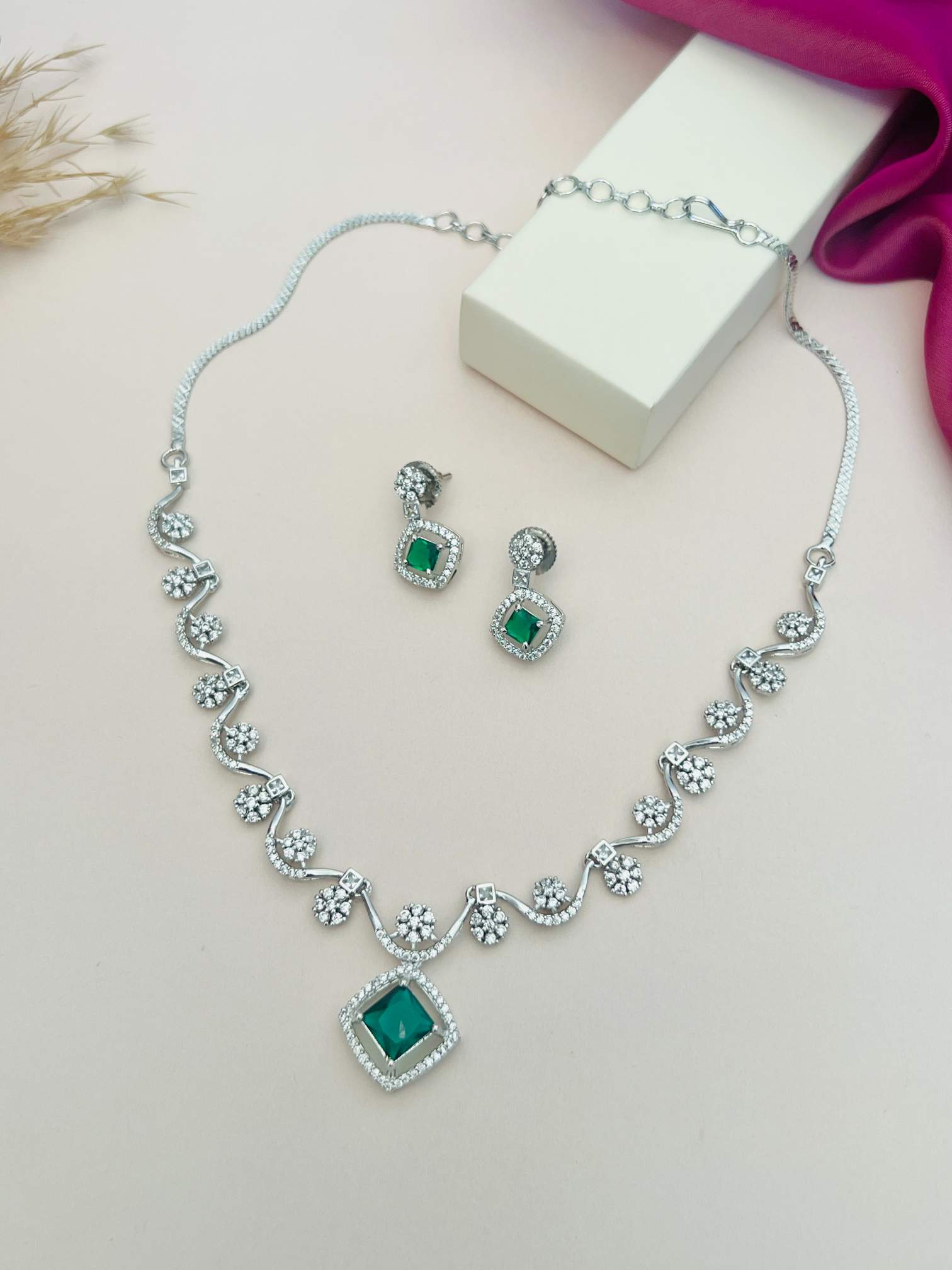Elegant Necklace with Sparkling Stones featuring green gemstone pendant and matching earrings