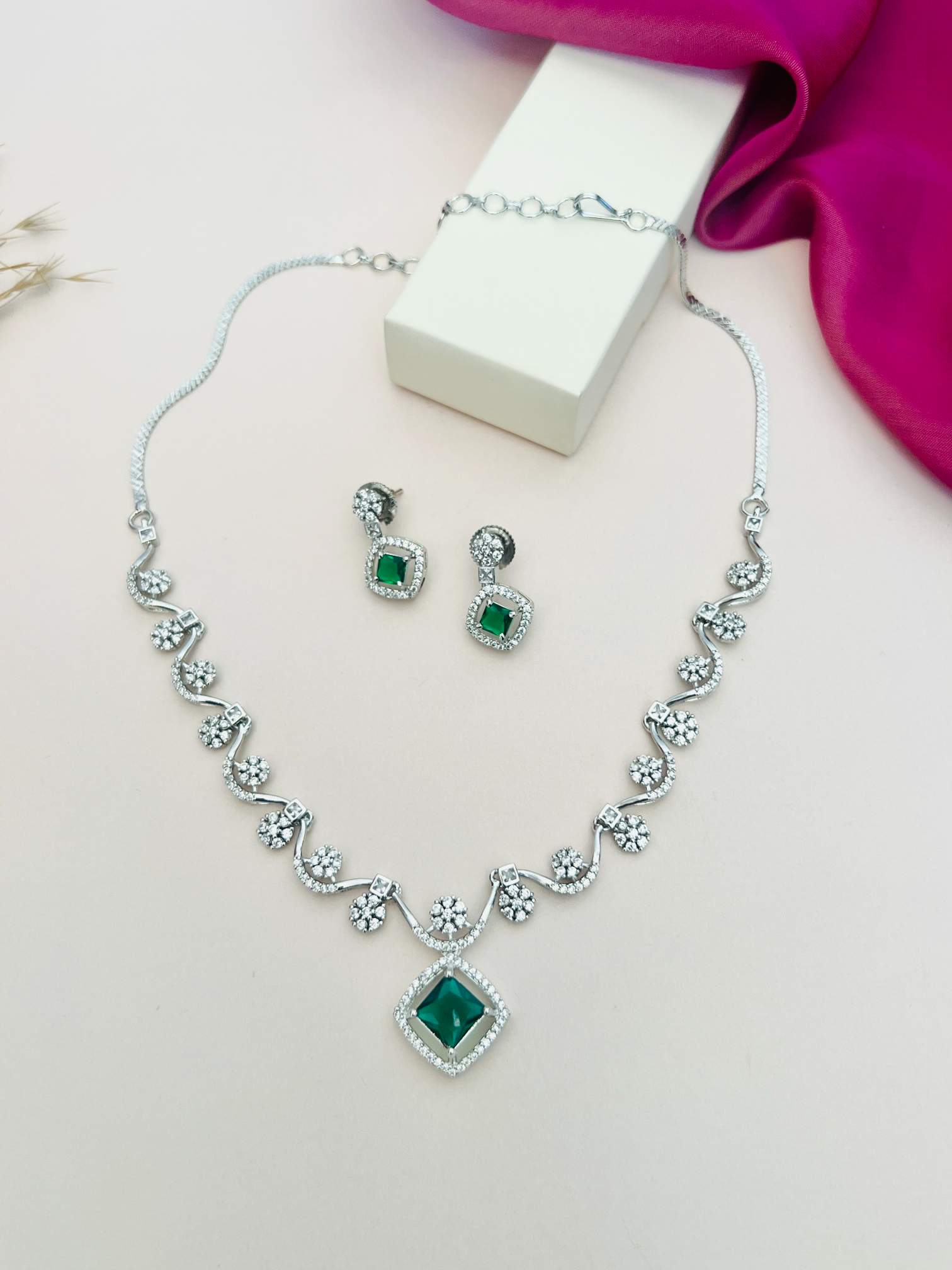 Elegant Necklace with Sparkling Stones featuring green center gems and matching earrings by Abdesignsjewellery