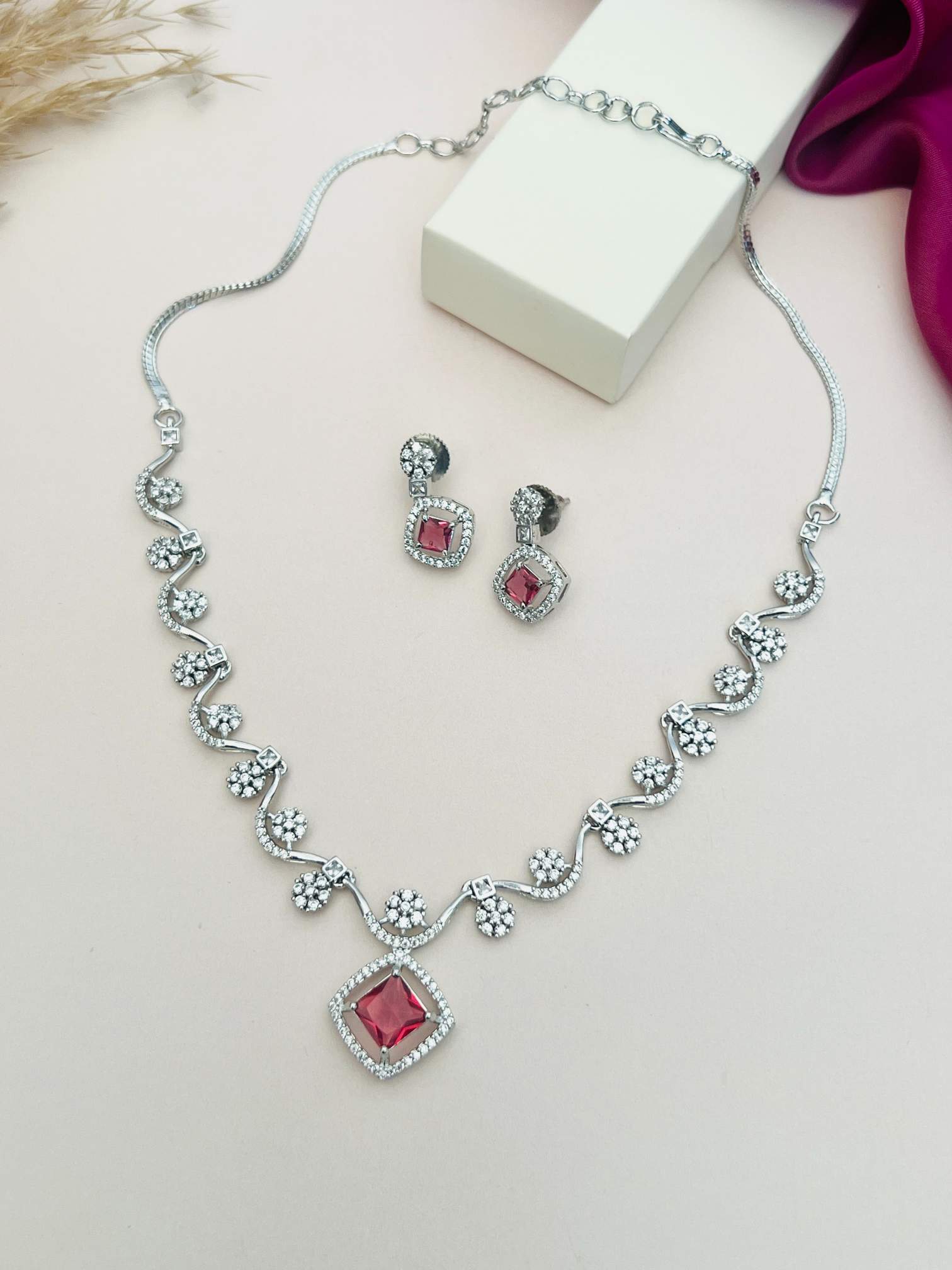 Elegant Necklace with Sparkling Stones featuring red center stones and matching earrings from Abdesignsjewellery