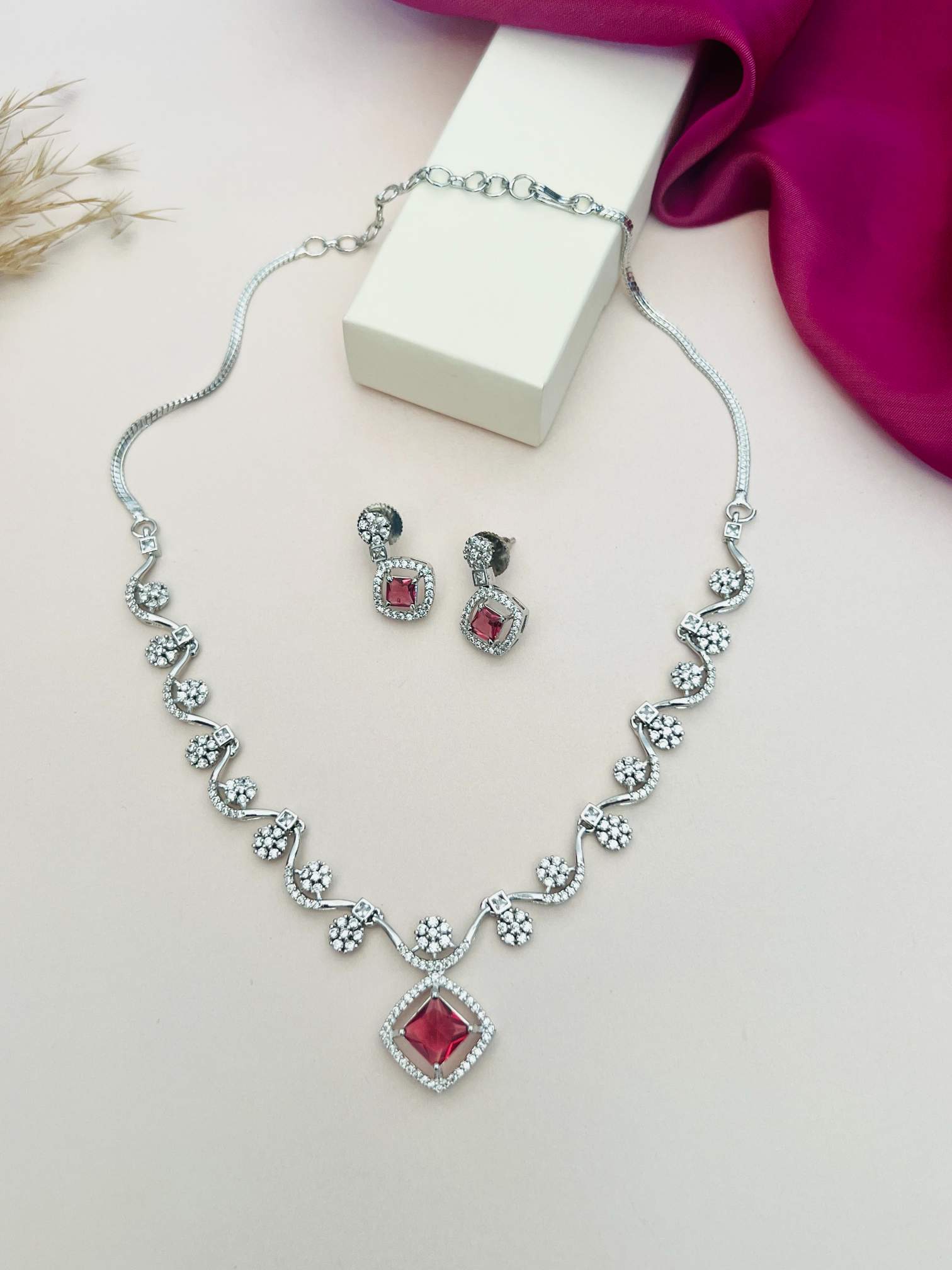 Elegant Necklace with Sparkling Stones featuring red gem pendants and matching earrings by Abdesignsjewellery