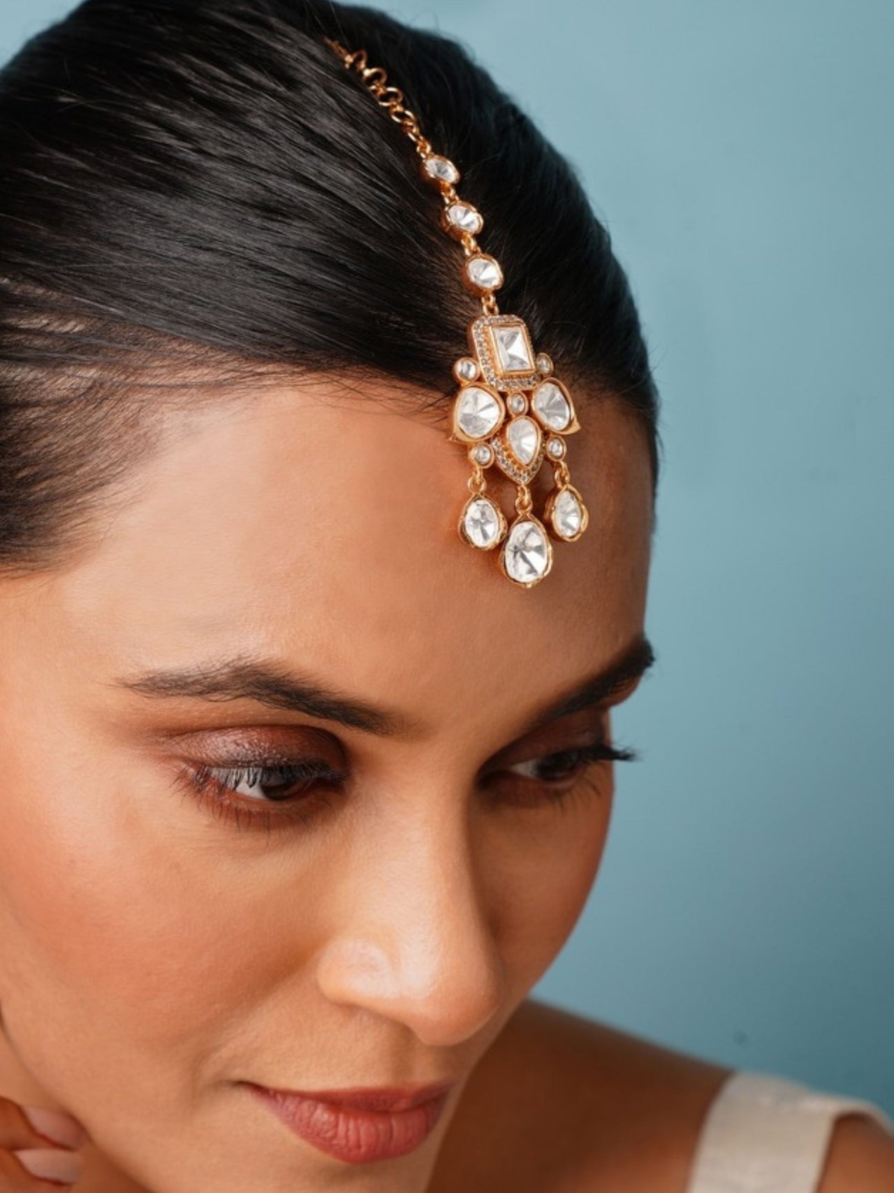 Elegant Polki Paachi Kundan Maangtikka worn by woman with gold and white stone detailing