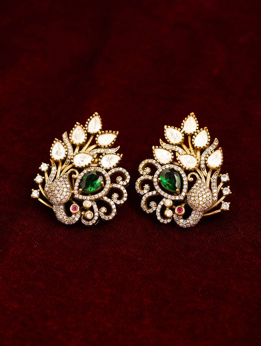 Abdesignsjewellery Emerald Antique Peacock Polki Stud Earring with green and white stones on dark red background