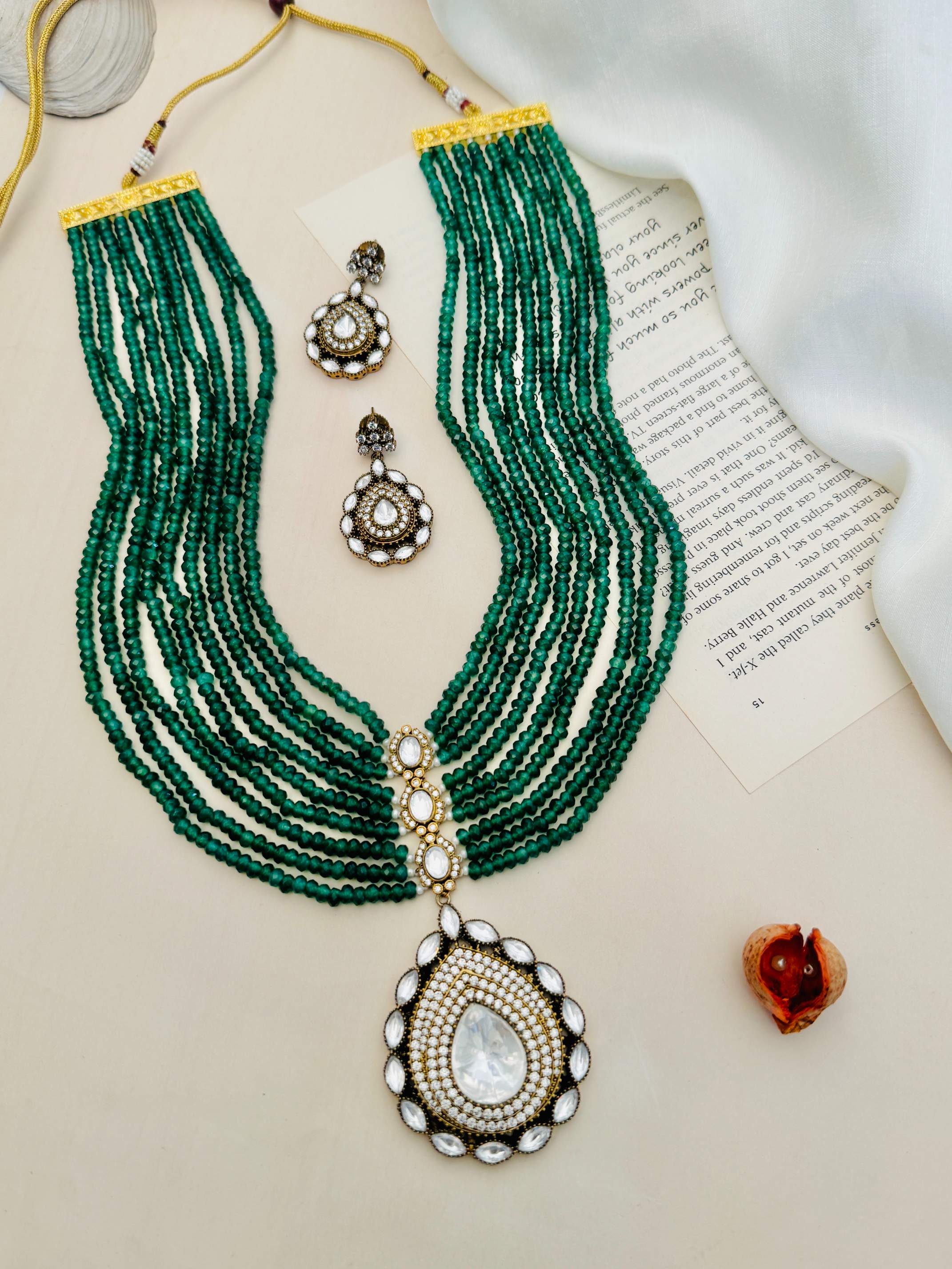 Emerald Green Polki Jaipuri Mala Set with multi-strand green beads and intricate white stone pendant with matching earrings
