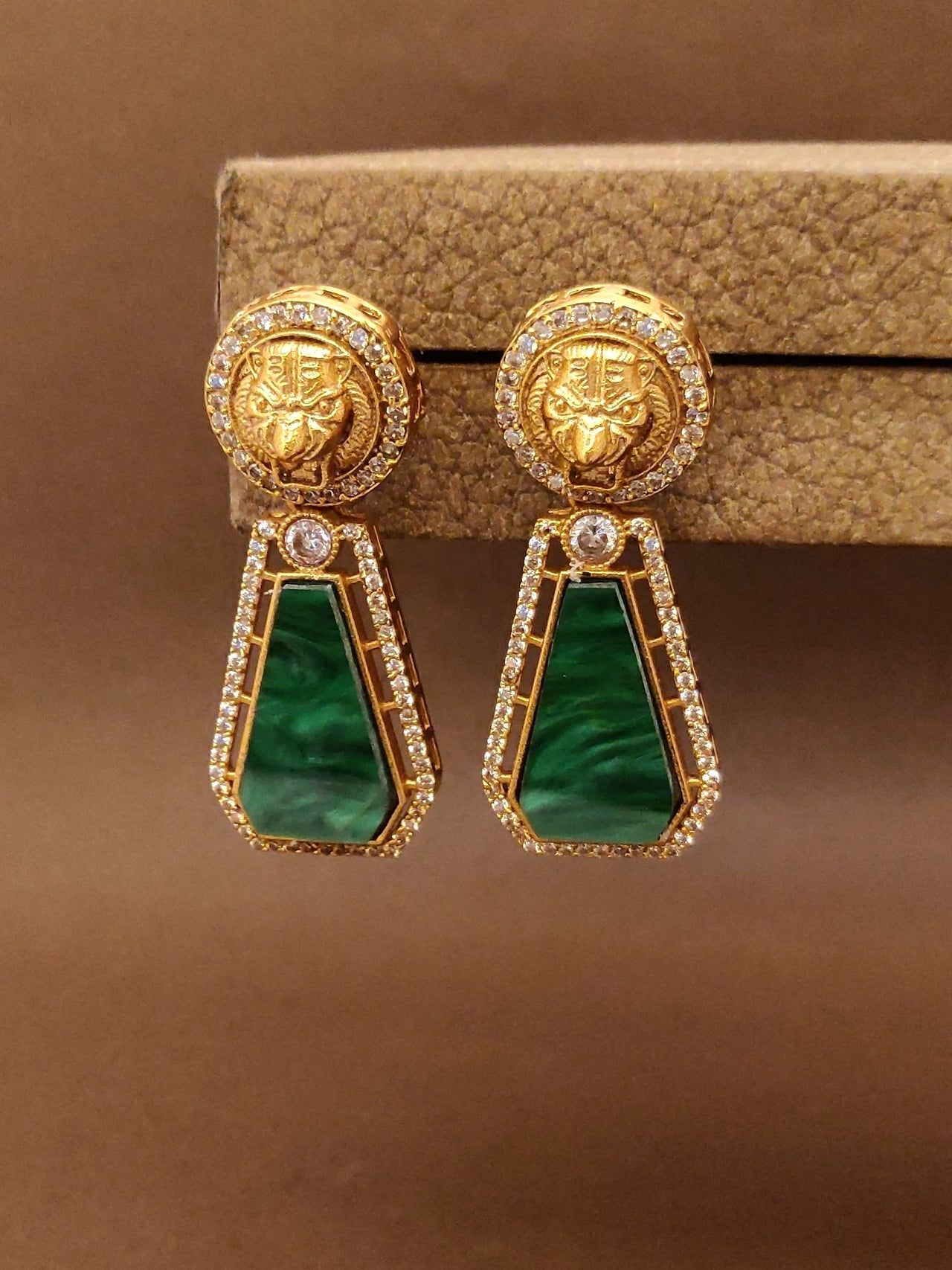 Emerald Sabyasachi Earrings with intricate gold design and sparkling stones, perfect for special occasions