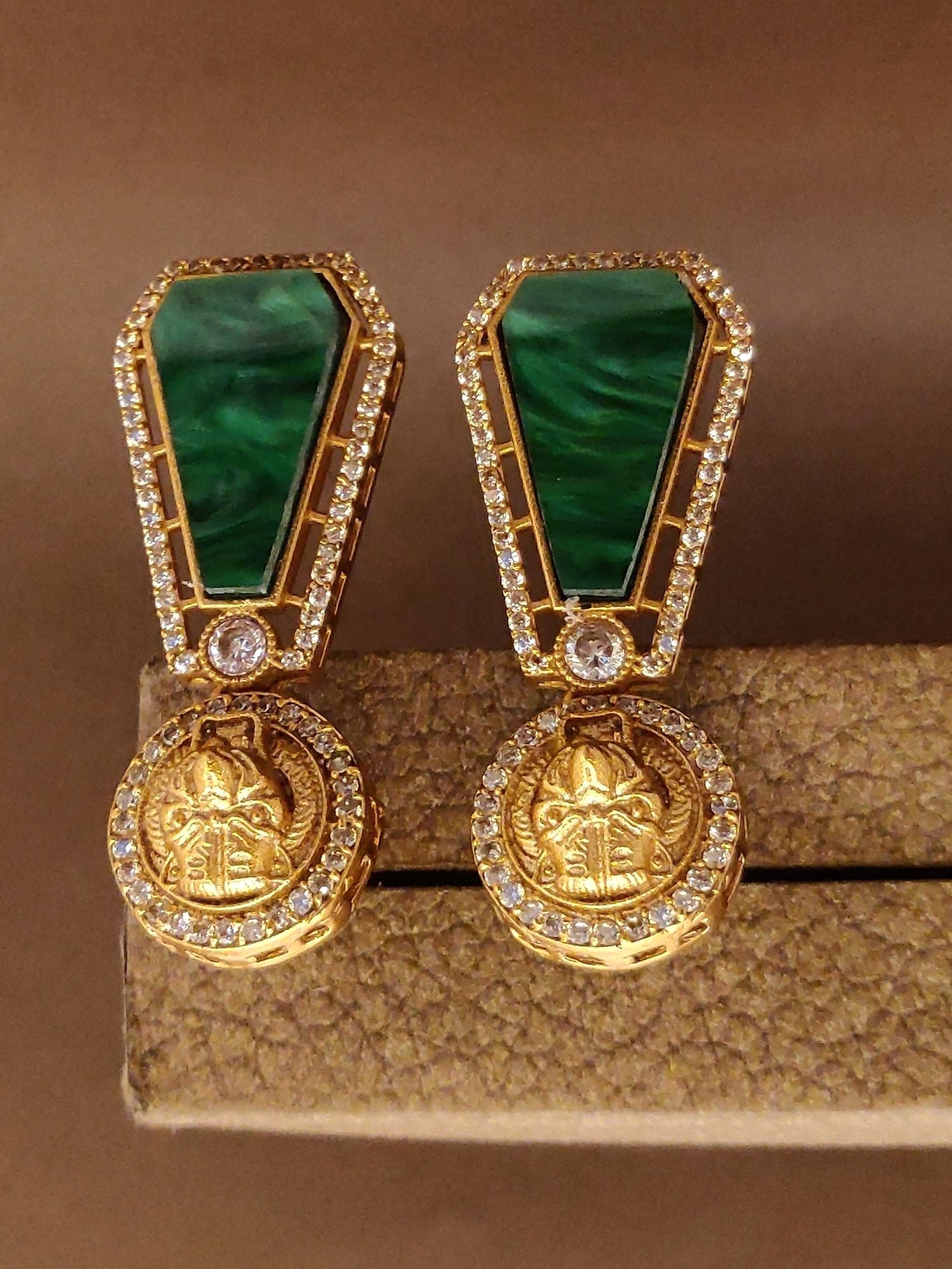Emerald Sabyasachi Earrings with Gold Accents and Sparkling Stones for Elegant Occasions