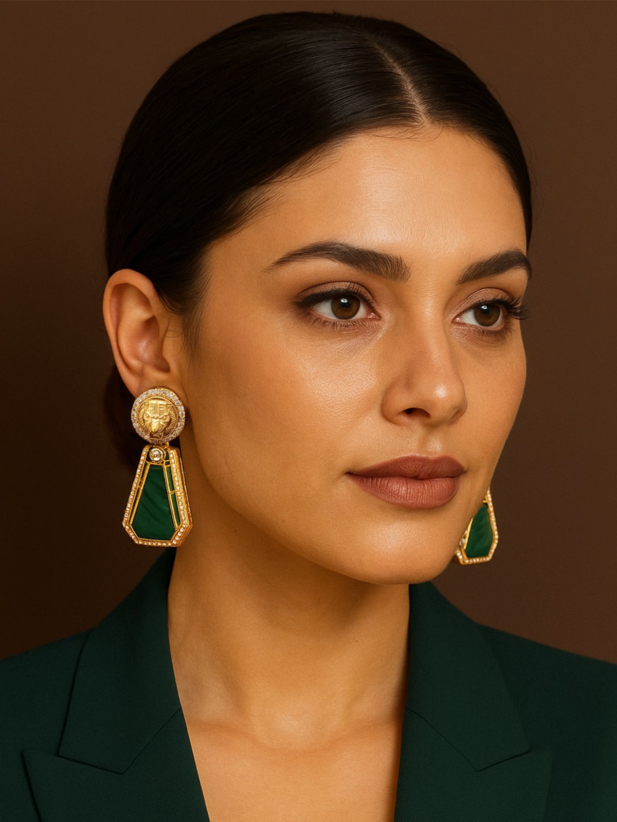 Emerald Sabyasachi Earrings featuring intricate gold detailing and vibrant green stones