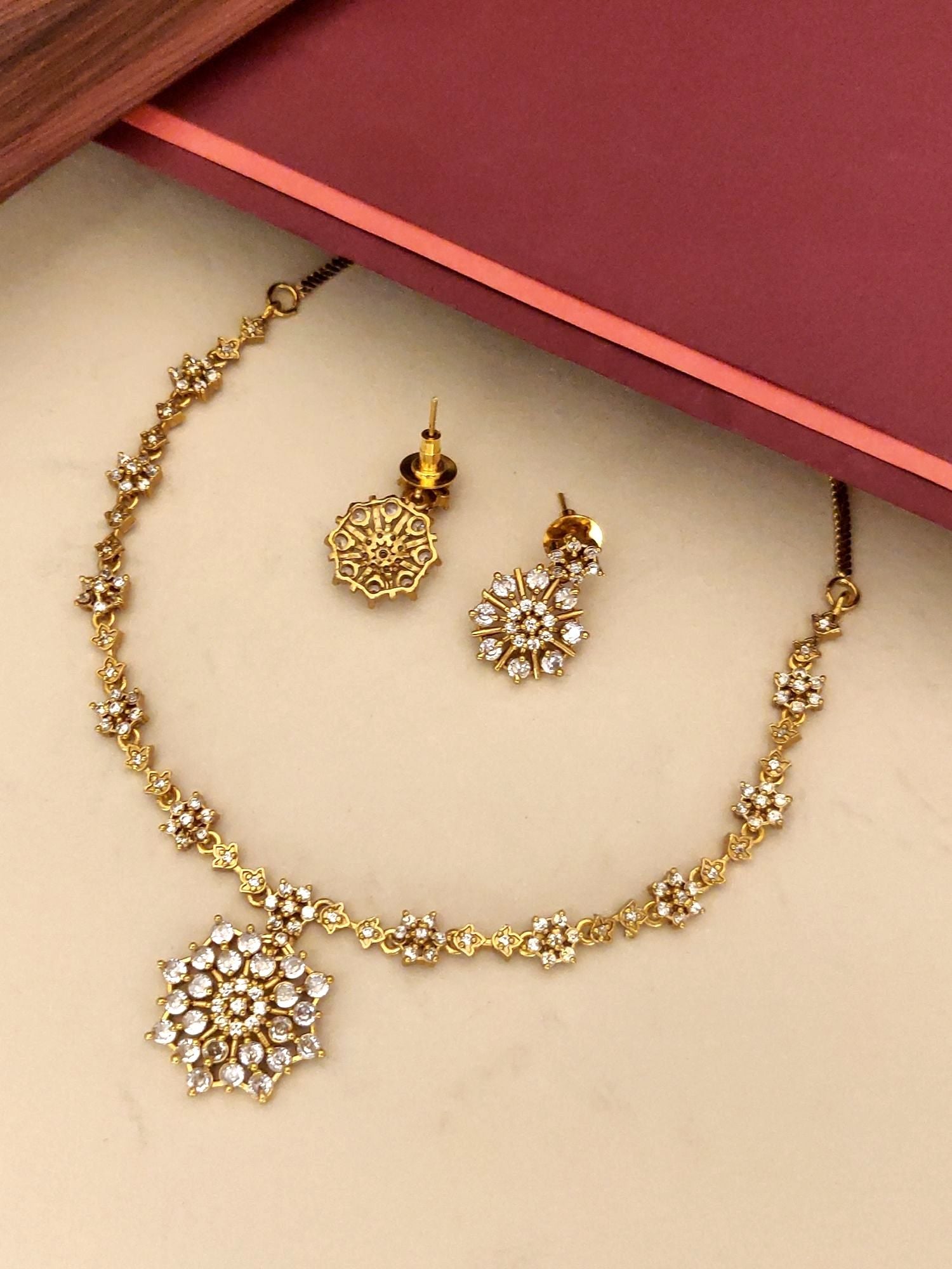 Extravagant Gold Plated American Diamond Necklace Set with Detailed Floral Pendant and Matching Earrings