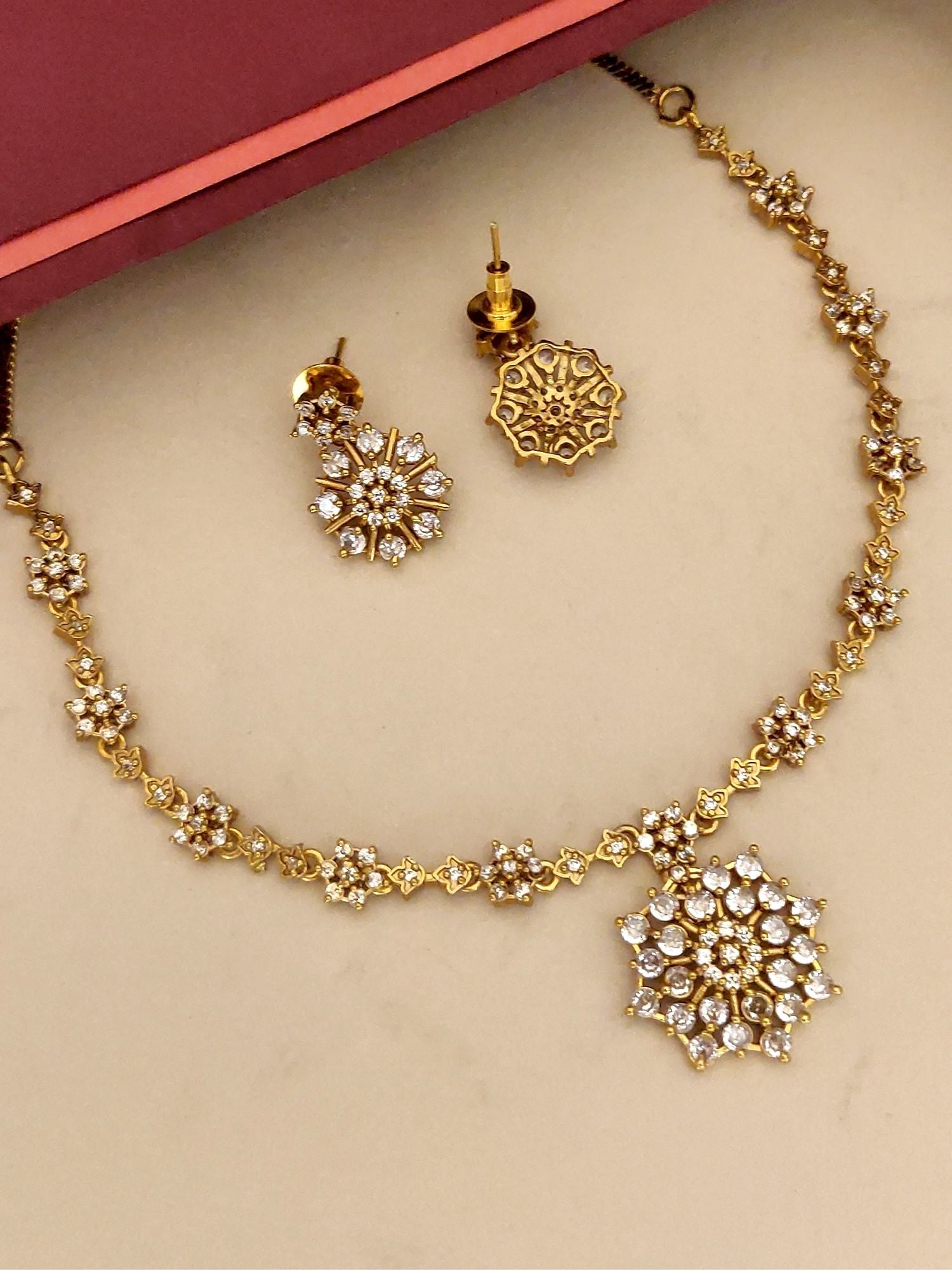 Extravagant Gold Plated American Diamond Necklace Set with Floral Design and Matching Earrings