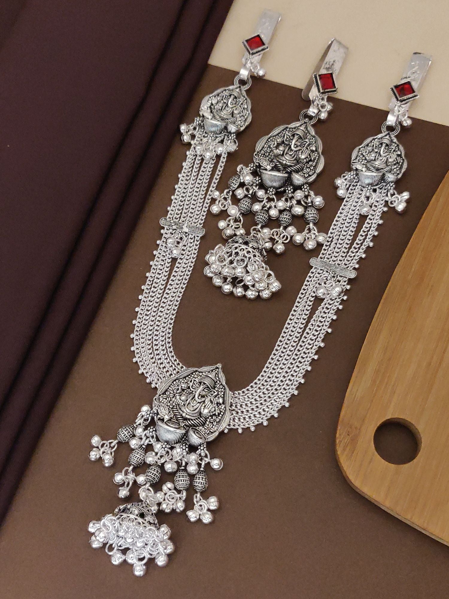 Ganesh style Juda pin set with intricate silver design and red accents, perfect for festive occasions