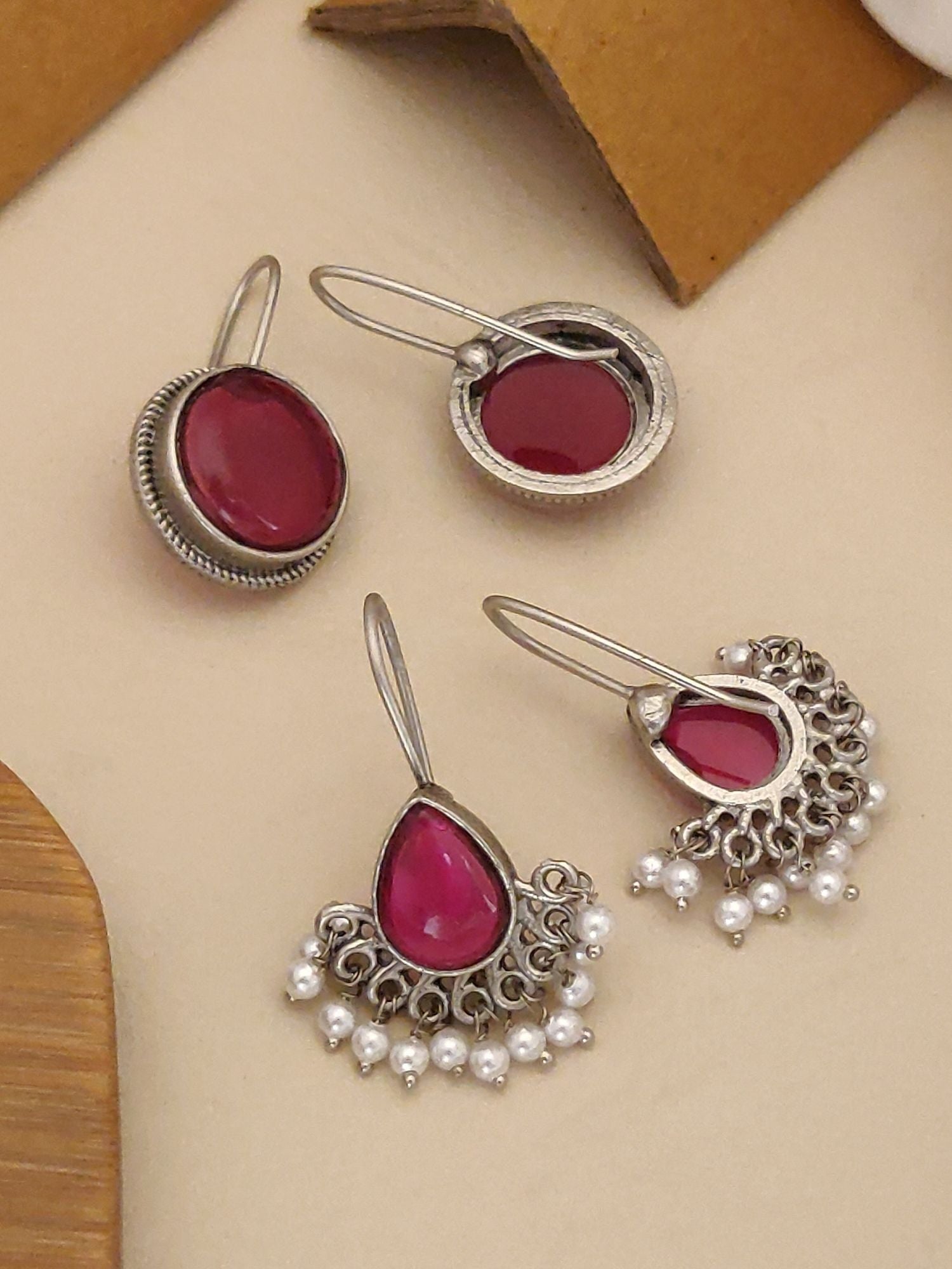 German Silver Set Of 2 Earring Combo featuring elegant designs with red stones and pearl accents