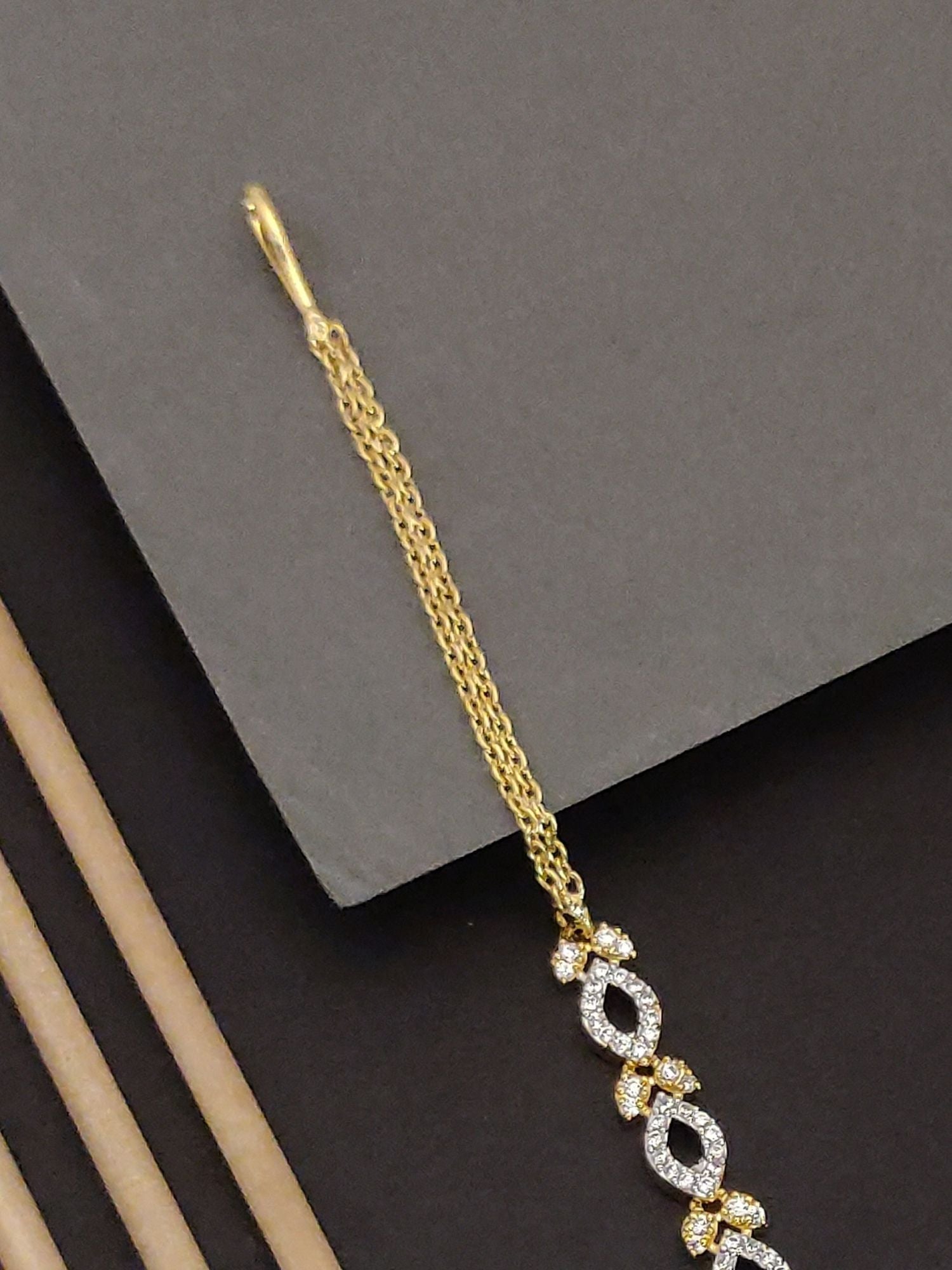 Gold Plated American Diamond Maangtikka with intricate design and elegant finish for traditional wear