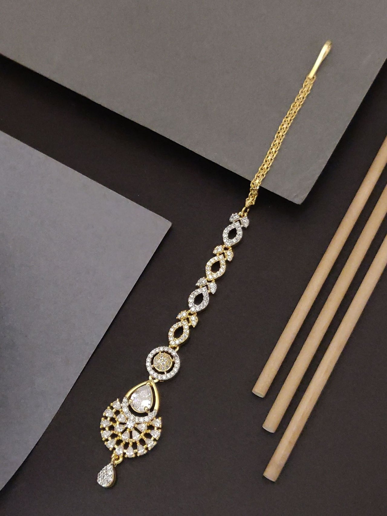 Gold Plated American Diamond Maangtikka with intricate design and sparkling details for elegant looks