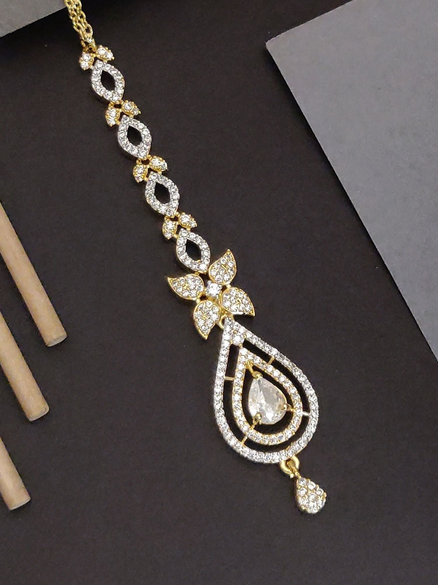 Gold Plated American Diamond Maangtikka with intricate design and sparkling accents for elegant hairstyle adornment