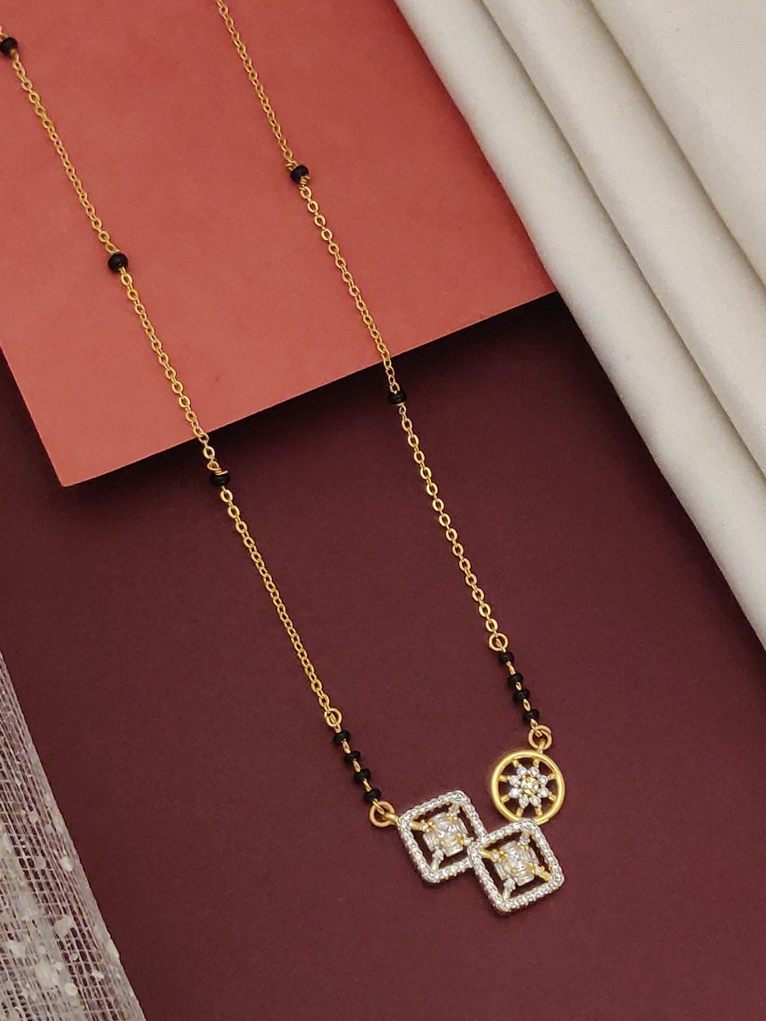 Gold Plated American Diamond Mangalsutra with black beads and geometric pendant by Abdesignsjewellery