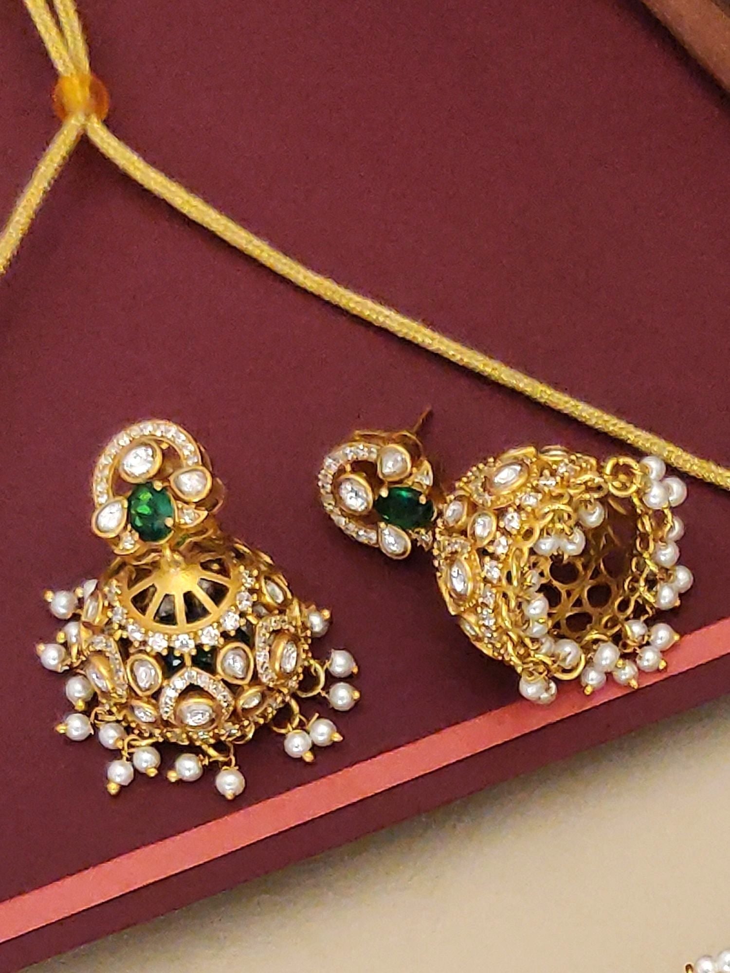 Gold Plated American Diamond Necklace Set featuring intricate designs and green accents