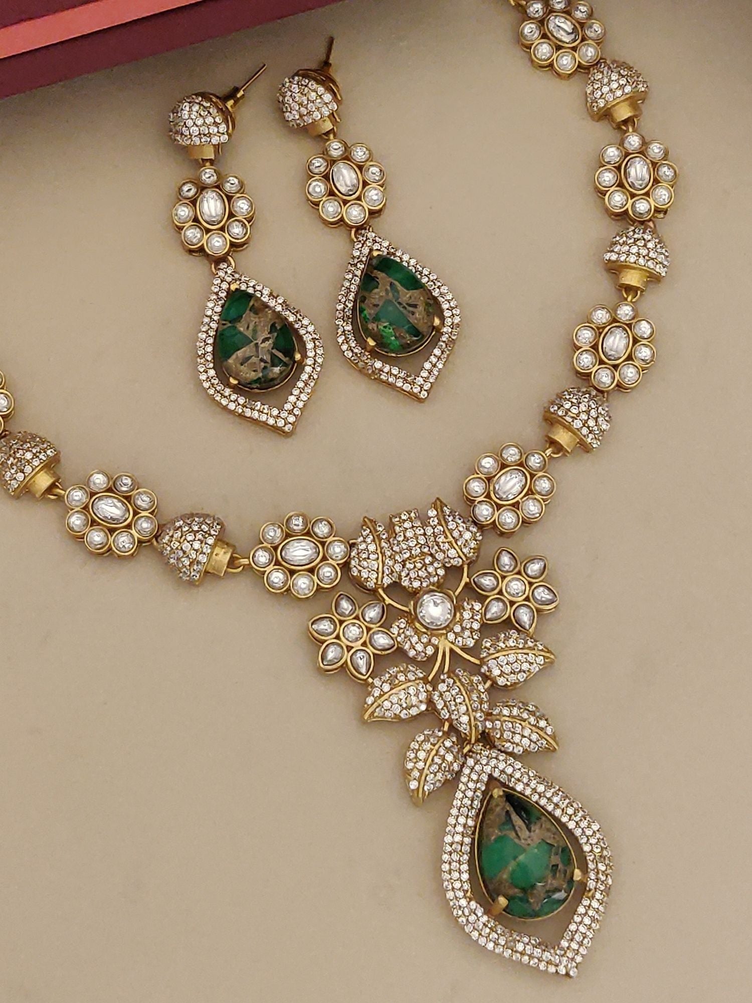 Gold Plated American Diamond Necklace with intricately designed floral motifs and matching earrings