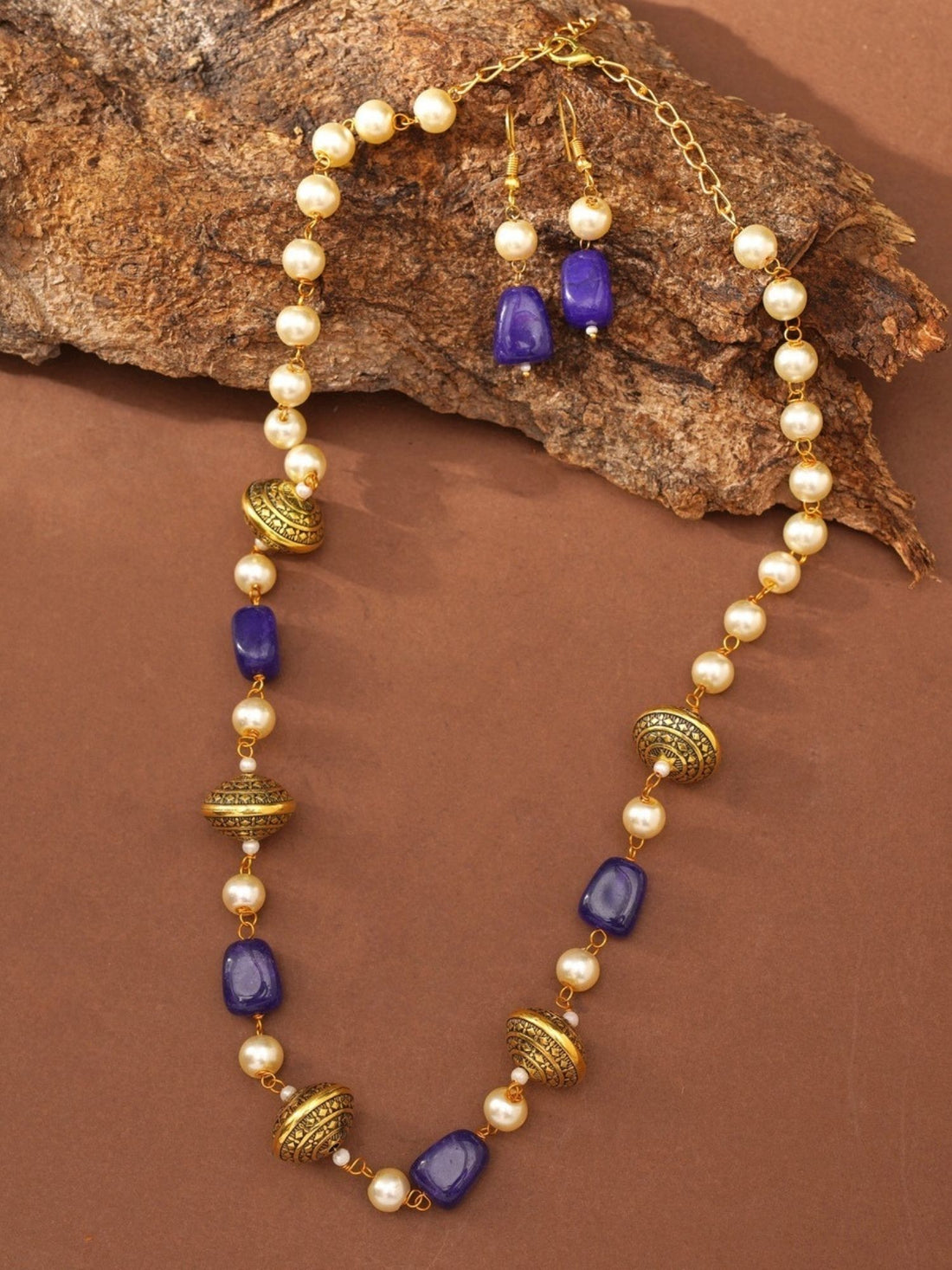 gold plated beaded necklace set on model with blue stone accents matching drop earrings and jasmine gajra