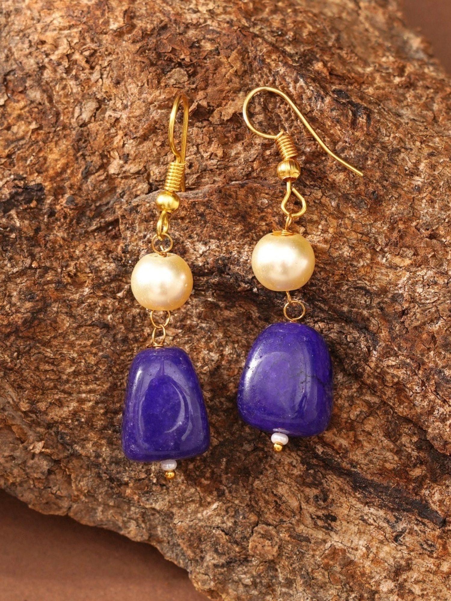 Abdesignsjewellery gold plated beaded necklace set display with gold hooks pearl and purple stone drop earrings on bark