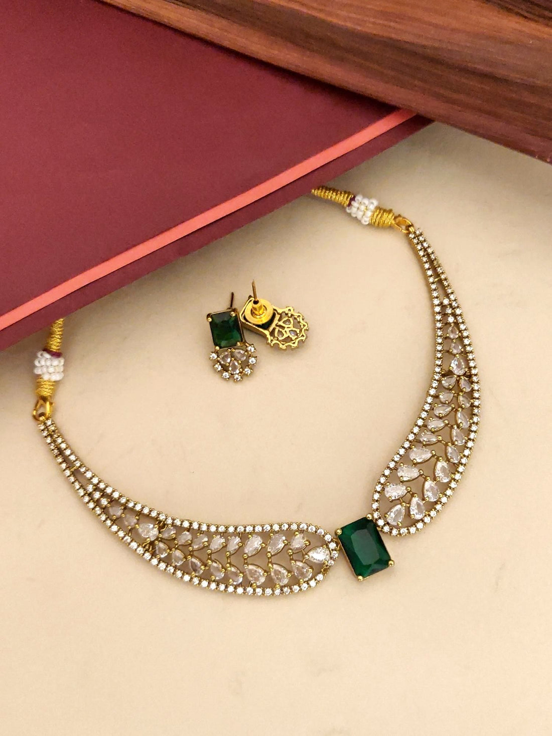 Elegant gold plated choker necklace set with emerald stone and intricate designs for special occasions