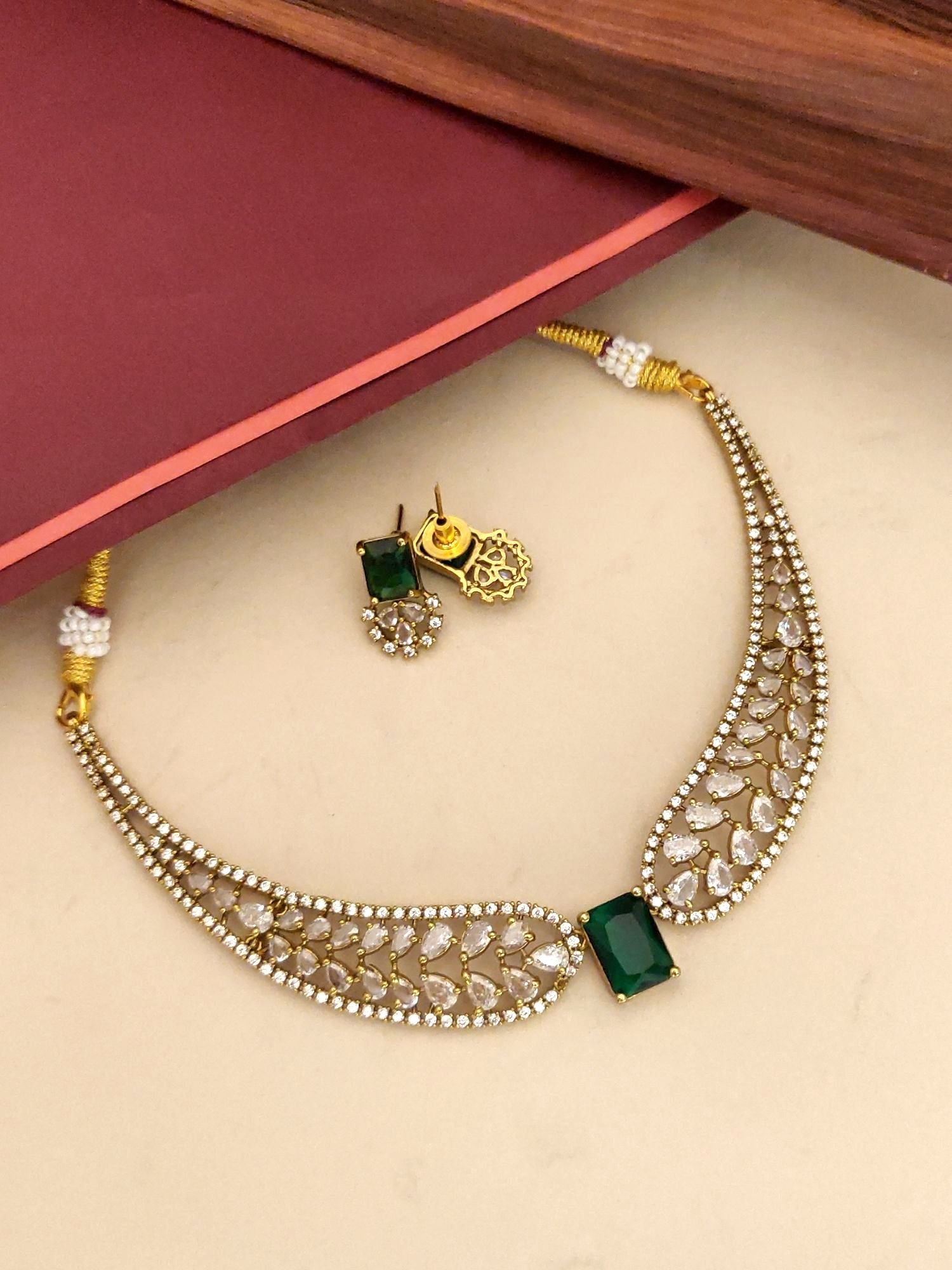 Elegant gold plated choker necklace set with emerald stone and intricate designs for special occasions