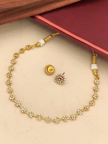 Gold plated diamond necklace set with intricate floral design and matching earrings