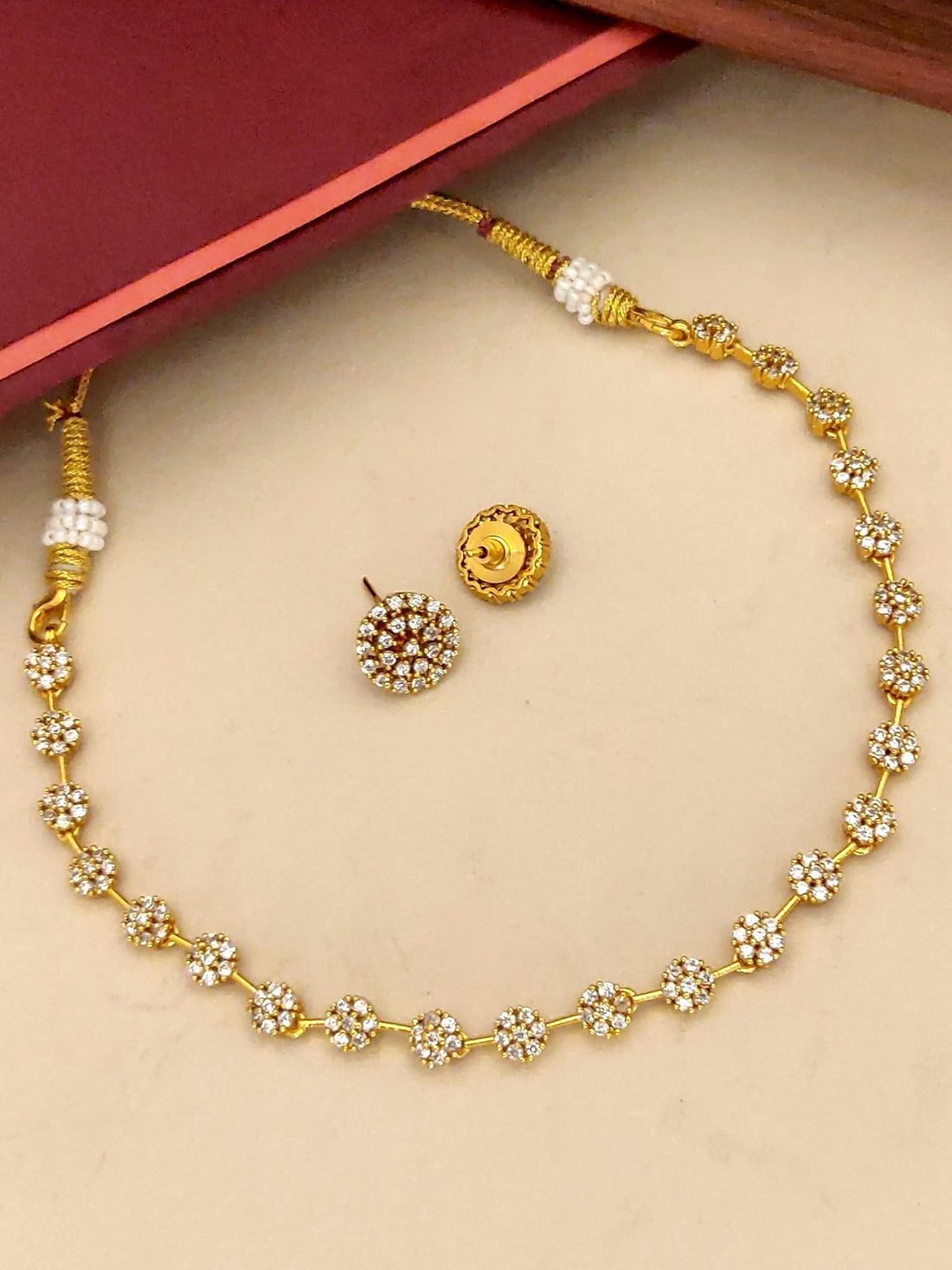 Gold plated diamond necklace set with intricate floral design and matching earrings